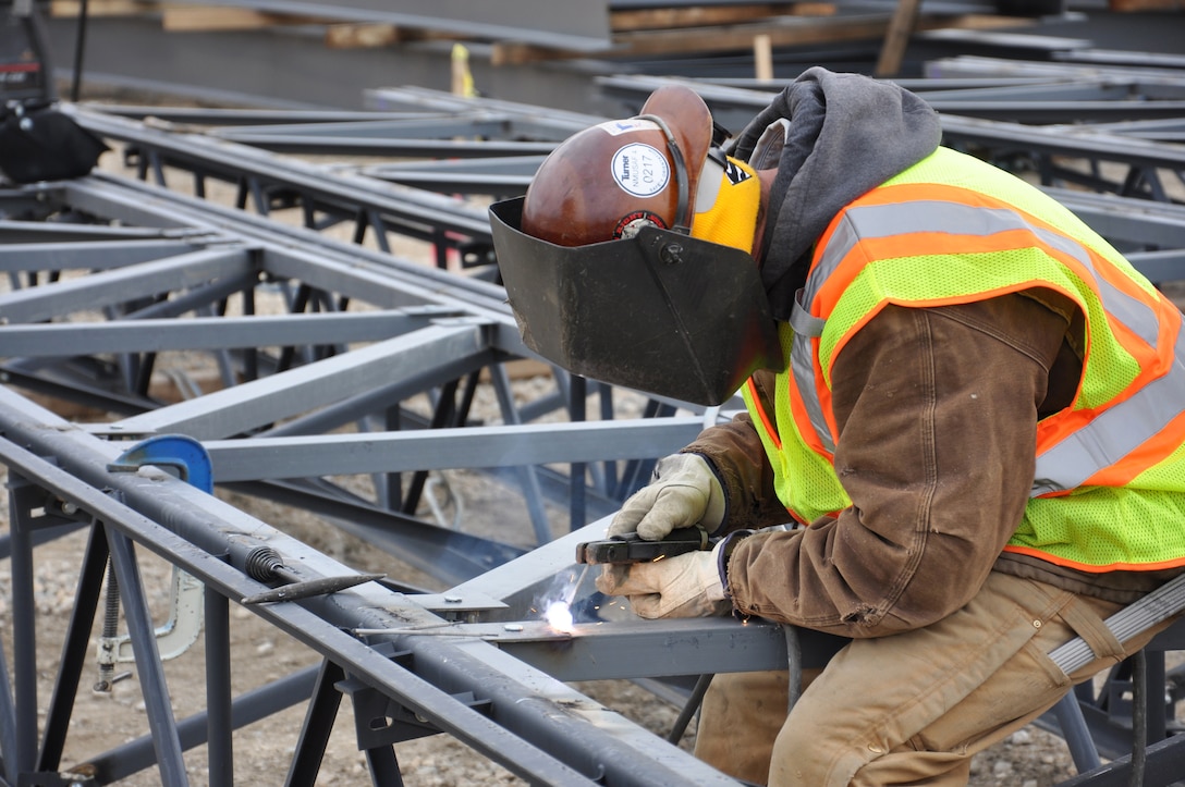 A contractor works on welding pieces of  steel trusses that will form the new fourth building of the National Museum of the United States Air Force near Dayton, Ohio.