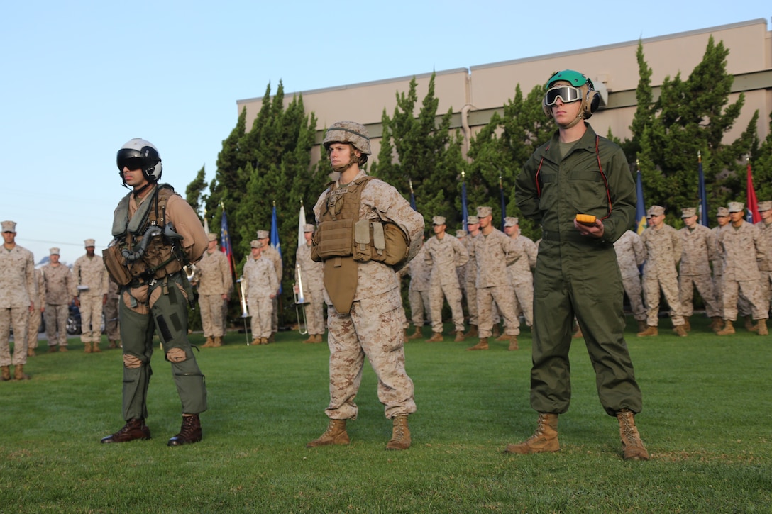 Three Marines stand symbolizing the many roles of Marines in the past thirteen years of combat operations by wearing different uniforms and combat gear aboard Marine Corps Air Station Miramar, Calif., Dec. 9. The Marines were part of a morning colors ceremony that recognized the end of the 3rd Marine Aircraft Wing’s operations in Afghanistan.