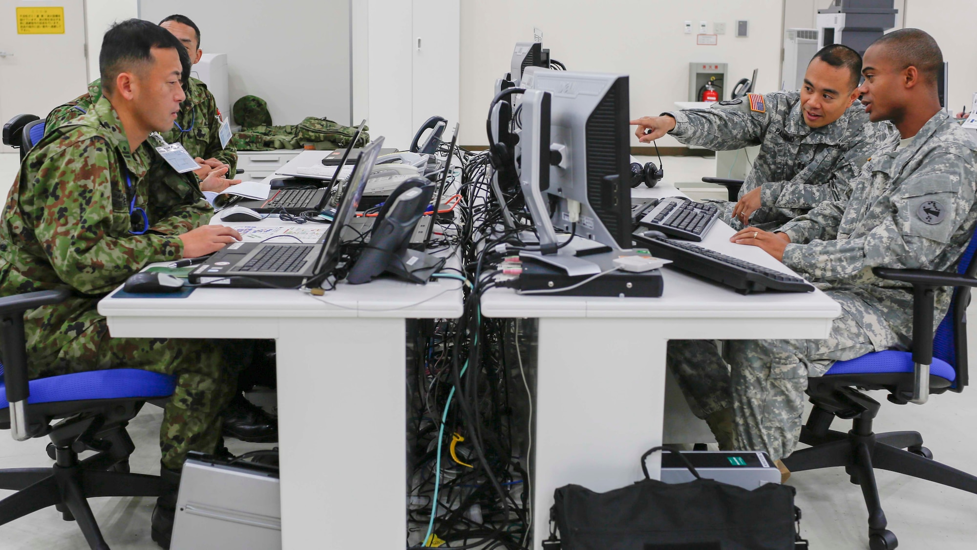 A group of Soldiers from the U.S. Army and Japan Ground Self-Defense Forces prepare for the Bilateral Air Coordination Center portion of the exercise during the Yama Sakura 67 at Yokota Air Base, Japan, Dec. 8, 2014.  Yama Sakura is an annual bilateral exercise between the U.S. Army and JGSDF.  (U.S. Air Force photo by Airman 1st Class Soo C. Kim / Released)