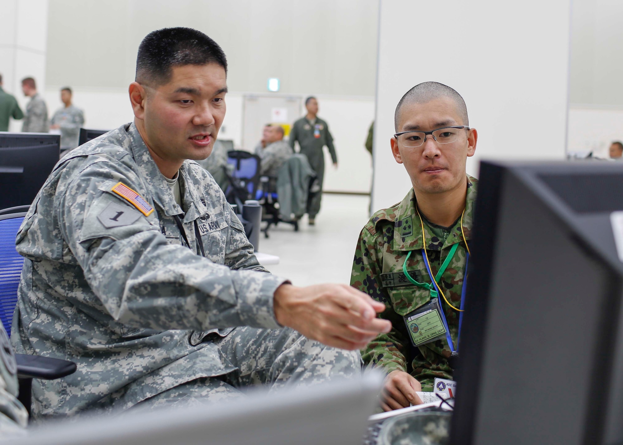 A U.S. Army Soldier and Japan Ground Self-Defense Force Soldier prepare for the Yama Sakura 67 exercise at Yokota Air Base, Japan, Dec. 8, 2014.  Yama Sakura is an annual bilateral exercise between the U.S. Army and JGSDF that is aimed at increasing combat readiness between the two nations.  (U.S. Air Force photo by Airman 1st Class Soo C. Kim / Released)