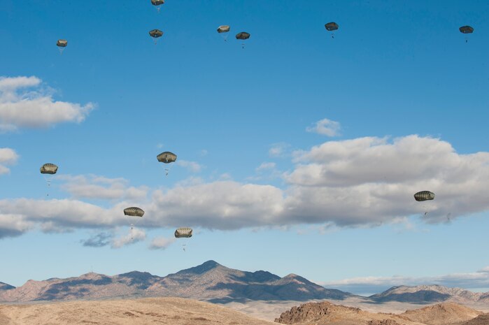 Paratroopers assigned to the 3rd Brigade Combat Team, 82nd Airborne Division, Fort Bragg, N.C., converge on their drop zone during the U.S. Air Force Weapons School's Joint Forcible Entry Exercise 14B over the Nevada Test and Training Range Dec. 6, 2014. The JFEX exercise is designed to simulate rapid deployment into a contested-degraded environment, and helps to maintain strong cohesion between Air Force and Army assets. (U.S. Air Force photo by Airman First Class Joshua Kleinholz)