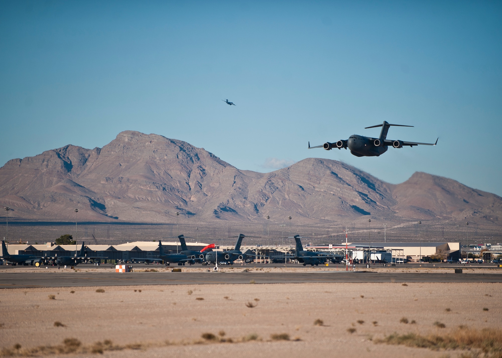 A C-17 Globemaster III launches during the U.S. Air Force Weapons School's Joint Forcible Entry Exercise 14B at Nellis Air Force Base, Nev., Dec. 6, 2014. The USAFWS's biannual JFE  exercises, which act as the capstone event for weapons school students, are large-scale air mobility exercises during which participants plan, seize and hold lodgments against armed opposition. (U.S. Air Force photo by Staff Sgt. Siuta B. Ika)