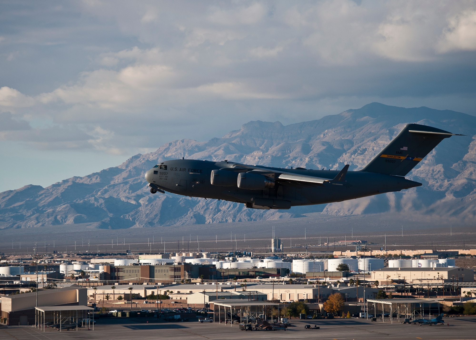 A U.S. Air Force C-17 Globemaster III takes off from Nellis Air Force Base, Nev. during the U.S. Air Force Weapons School's Joint Forcible Entry Exercise 14B Dec. 6, 2014. The C-17 is capable of rapid strategic delivery of troops and all types of cargo to main operating bases or directly to forward bases in the deployment area. (U.S. Air Force photo by Airman 1st Class Mikaley Towle)