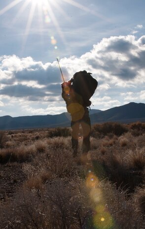 A paratrooper assigned to the 3rd Brigade Combat Team, 82nd Airborne Division, Fort Bragg, N.C., makes his way to the rally point during the U.S. Air Force Weapons School's Joint Forcible Entry Exercise 14B on the Nevada Test and Training Range Dec. 6, 2014. More than 100 paratroopers jumped from multiple C-17 Globemaster IIIs and C-130 Hercules as part of training for the USAFWS training to tactically deliver and recover combat forces via air drops and combat landings on an unimproved landing strip. (U.S. Air Force photo by Staff Sgt. Victoria Sneed)