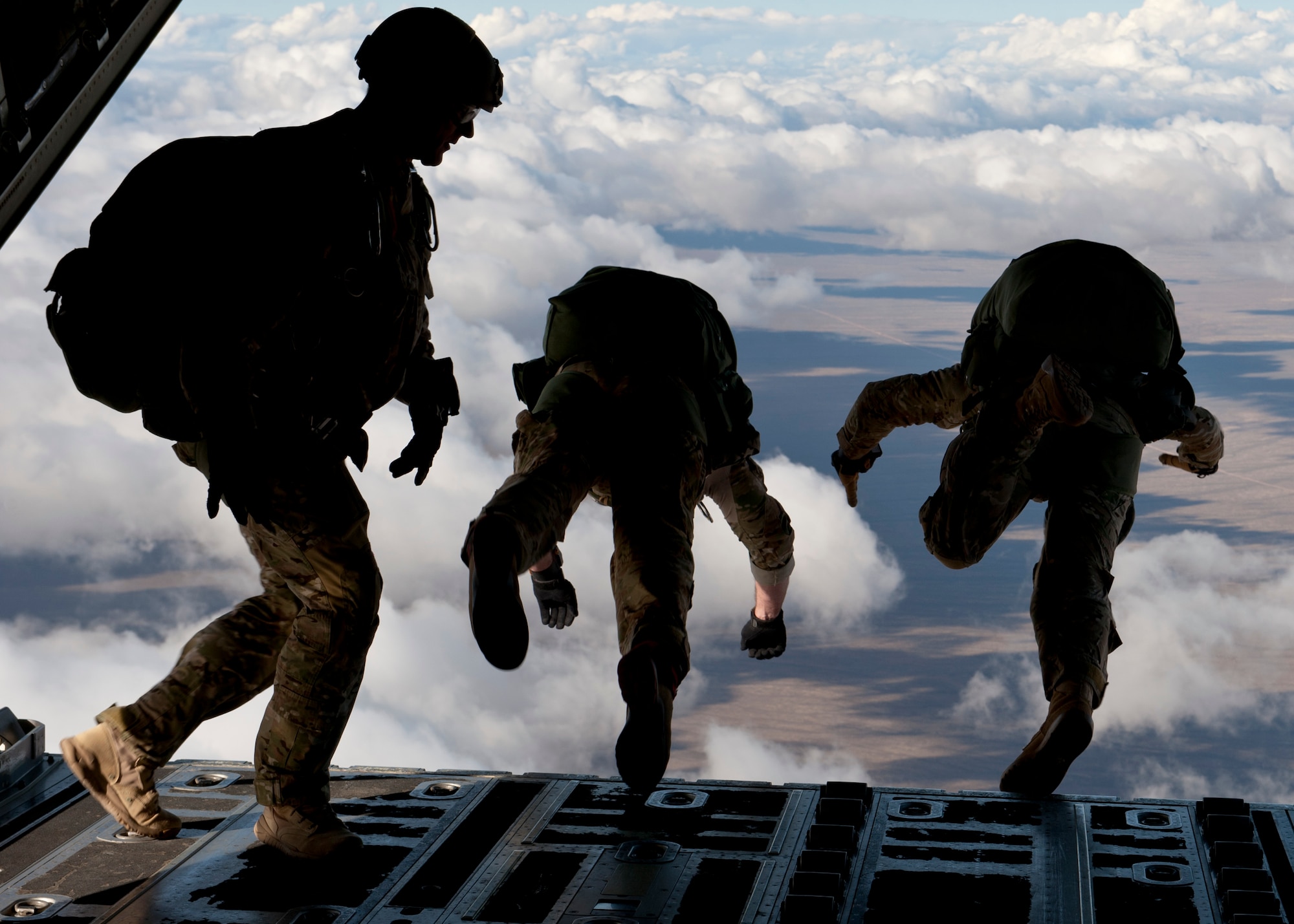 U.S Army Long Range Surveillance paratroopers and a U.S. Air Force Joint Terminal Attack Controller preform a High Altitude Low Opening jump during the U.S. Air Force Weapons School's Joint Forcible Entry Exercise 14B over the Nevada Test and Training Range Dec. 4, 2014. Joint service exercises such as JFEX help to maintain mission readiness and effectiveness for future real-world joint-service operations. (U.S. Air Force photo by Senior Airman Thomas Spangler)