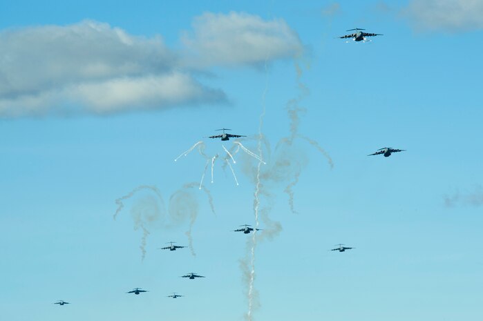 U.S. Air Force C-17 Globemaster IIIs assigned to March Air Reserve Base, Calif., deploy flares to avoid simulated anti-aircraft missiles during the U.S. Air Force Weapons School's Joint Forcible Entry Exercise 14B over the Nevada Test and Training Range Dec. 6, 2014. JFEX, as part of a restructured integration phase in the U.S. Air Force Weapons School, is a prime example of the advanced training students receive throughout the course. (U.S. Air Force photo by Senior Airman Timothy Young)