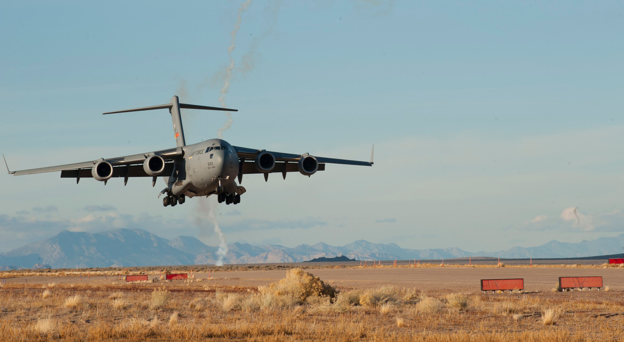 A U.S. Air Force C-17 Globemaster III assigned to March Air Reserve Base, Calif., approaches for landing on a degraded airfield during the U.S. Air Force Weapons School's Joint Forcible Entry Exercise 14B at the Nevada Test and Training Range Dec. 6, 2014. The C-17 is capable of rapid strategic delivery of troops and all types of cargo to main operating bases or directly to forward bases in the deployment area. (U.S. Air Force photo by Airman First Class Joshua Kleinholz)