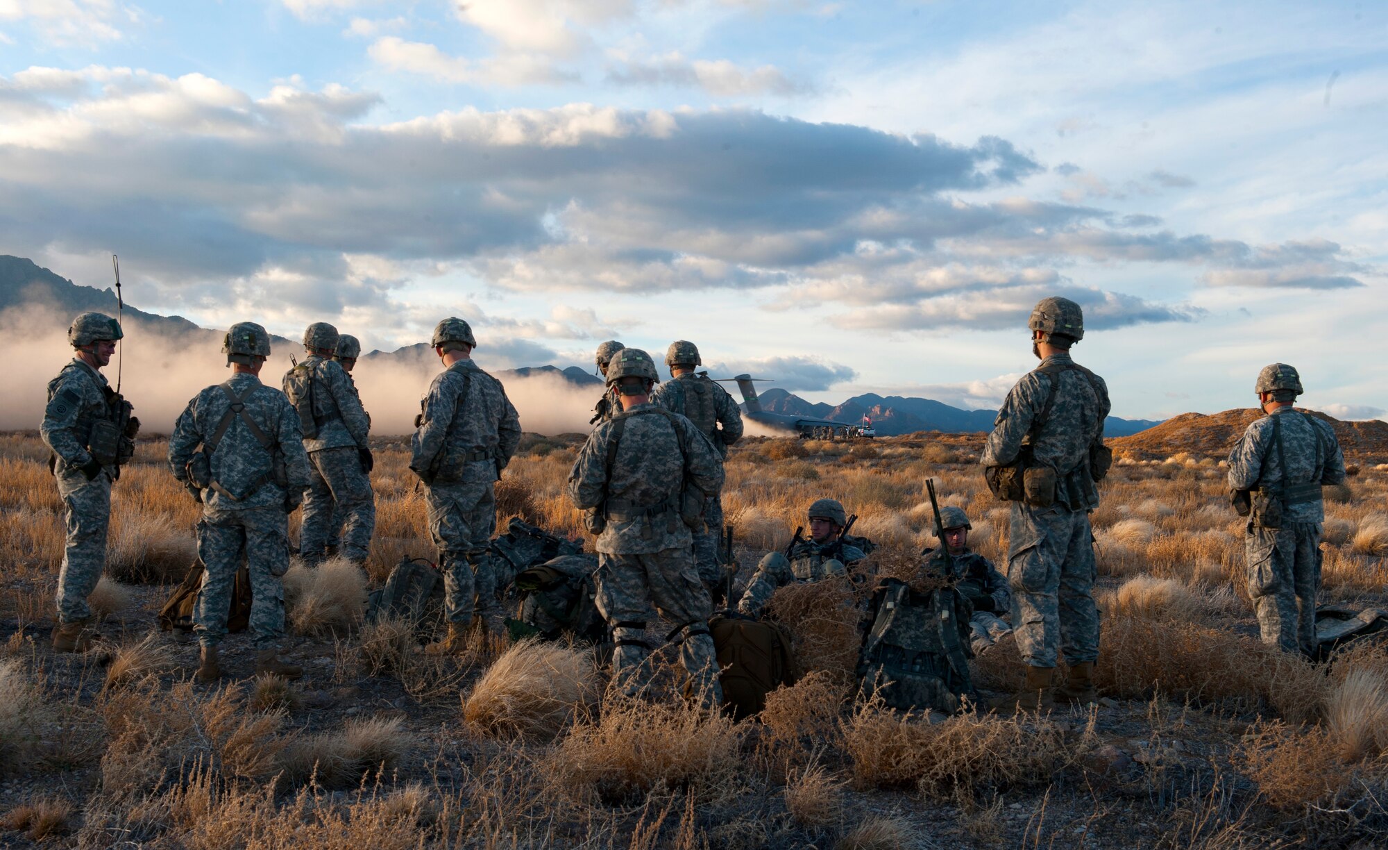 Paratroopers assigned to 3rd Brigade Combat Team, 82nd Airborne Division, Fort Bragg, N.C., watch a C-17 Globemaster III take off during the U.S. Air Force Weapons School's Joint Forcible Entry Exercise 14B on the Nevada Test and Training Range Dec. 6, 2014. More than 100 paratroopers and approximately 100 aircraft participated in the exercise as part of the USAFWS’ large-scale air mobility exercise to train students to contribute strategically to a joint operation. (U.S. Air Force photo by Staff Sgt. Victoria Sneed)