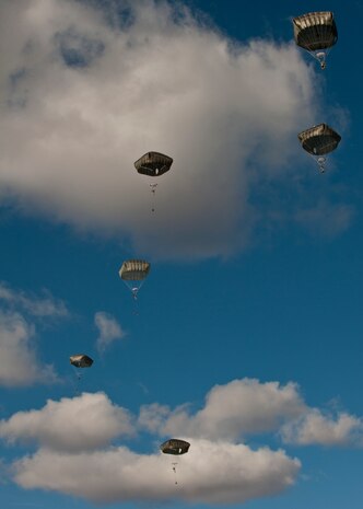 Paratroopers assigned to the 3rd Brigade Combat Team, 82nd Airborne Division, Fort Bragg, N.C., glide to their drop zone during the U.S. Air Force Weapons School's Joint Forcible Entry Exercise 14B on the Nevada Test and Training Range Dec. 6, 2014. JFEX, as part of a restructured integration phase in the USAFWS, is a prime example of the training students get to synchronize aircraft movements from geographically separated bases, command large formations of dissimilar aircraft in high-threat airspace, and tactically deliver and recover combat forces via air drops and combat landings on an unimproved landing strip. (U.S. Air Force photo by Staff Sgt. Victoria Sneed)