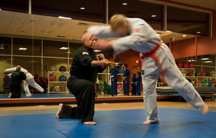 Robert McIntosh, 99th Civil Engineer Squadron, practices avoiding an obstacle, landing and returning to his feet as part of the Nesei Bujutsu class at the Warrior Fitness Center on Nellis Air Force Base, Nev., Dec. 9, 2014. The class teaches students, ages six and up, discipline, self-control and self-defense skills three days a week at the fitness center. (U.S. Air Force photo by Staff Sgt. Victoria Sneed)