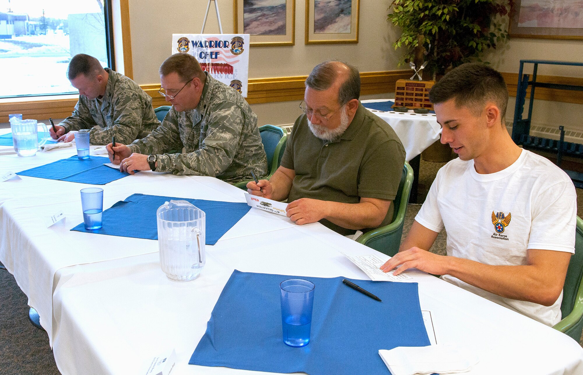 Judges critique team presentations at the Elkhorn Dining Facility Dec. 4 during the Fourth Quarter Warrior Chef Competition. From left to right are Col. Ken Speidel, 341st Maintenance Group commander; Lt. Col. Allan Fiel, 341st Security Forces Group vice commander; Gerrard Contreras, Malmstrom Air Force Base Commissary manager; and Senior Airman Austin Beaty, 341st Communications Squadron member and Air Force Association representative. (U.S. Air Force photo/Tech. Sgt. Christina Perchine)