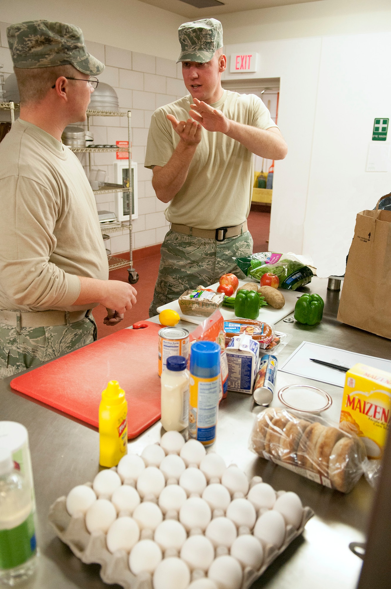 Tech. Sgts. Steven Vatsaas, right, and Michael McGrath, 12th Missile Squadron facility managers, plan the meal they will prepare from the groceries just revealed to them Dec. 4 during the Fourth Quarter Warrior Chef Competition at the Elkhorn Dining Facility. In a change from previous Warrior Chef competitions, two of the five competing teams were from outside of the Services career field. (U.S. Air Force photo/Tech. Sgt. Christina Perchine) 