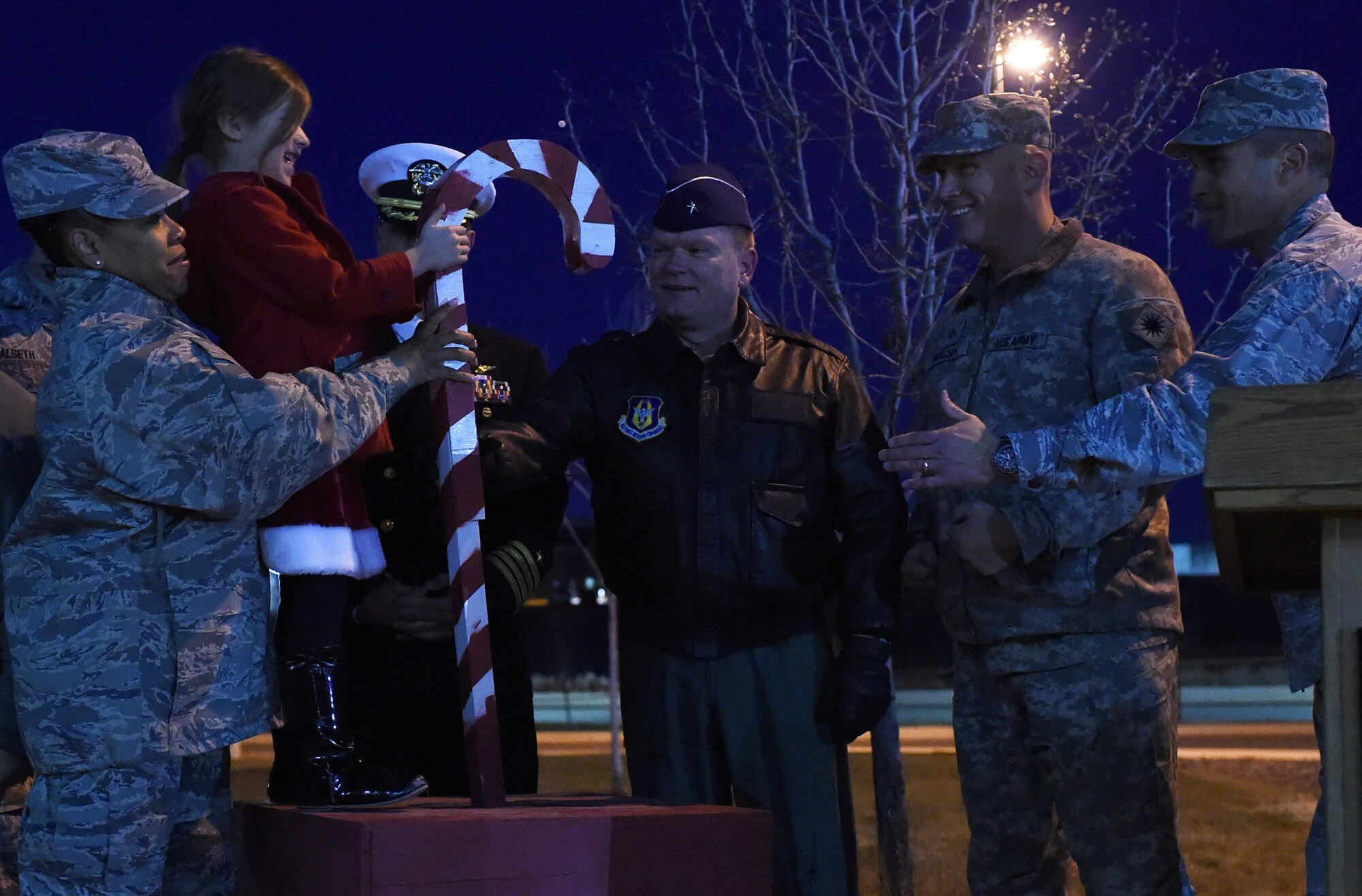 A 460th Space Wing ‘panther cub’ helps Team Buckley commanders and chiefs flip the switch to light the base tree during a tree-lighting ceremony Dec. 9, 2014, at the 460th SW headquarters building on Buckley Air Force Base, Colo. The annual tree lighting concluded with a visit from the 460th SW mascot, Buck Lee, dressed as Santa Claus, as well as hot chocolate and cookies. (U.S. Air Force photo by Airman 1st Class Samantha Saulsbury/Released)