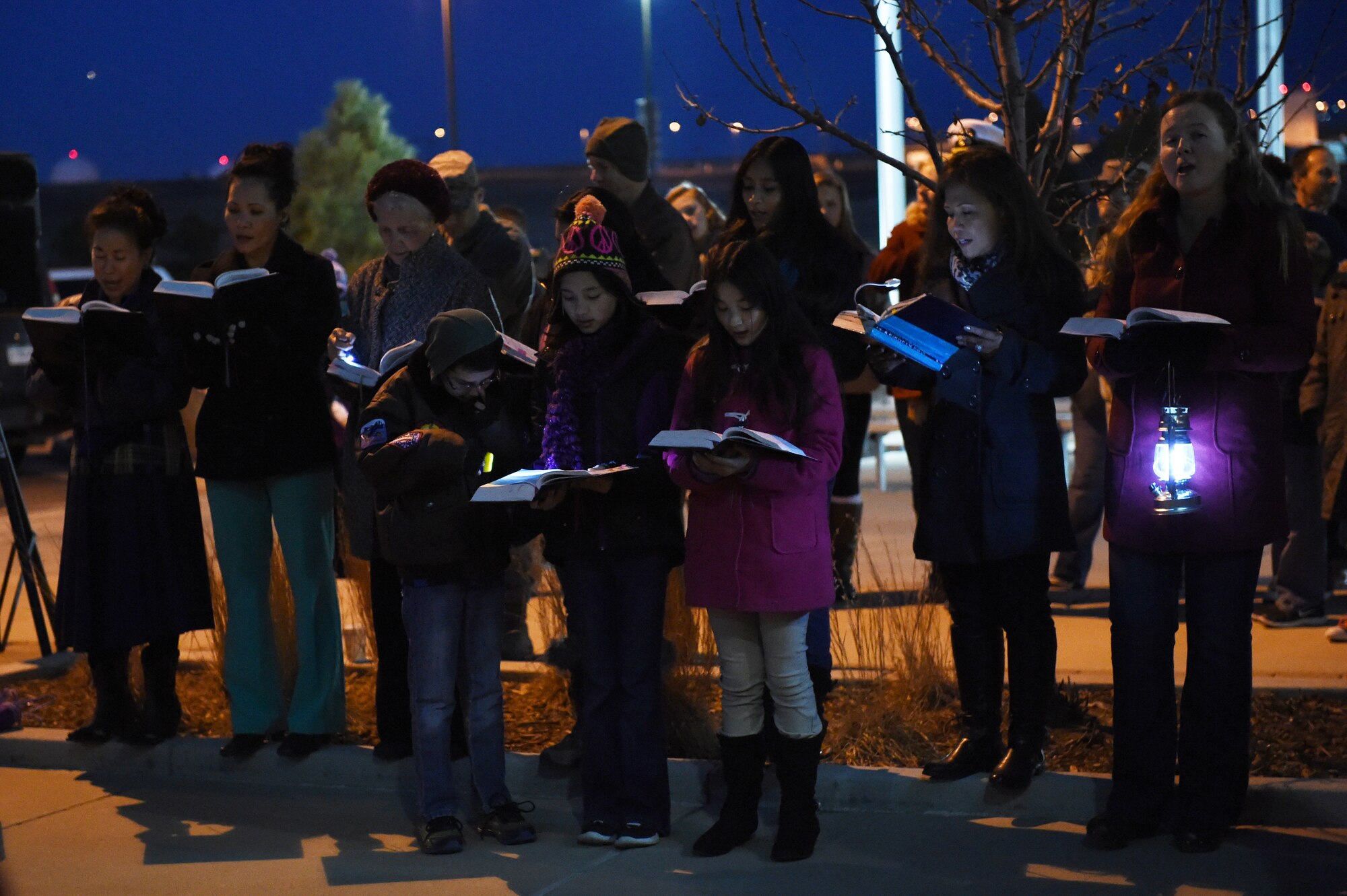 Members of the Buckley Chapel Catholic Choir Group sing Christmas songs during a tree-lighting ceremony Dec. 9, 2014, at the 460th Space Wing headquarters building on Buckley Air Force Base, Colo. The annual tree lighting concluded with a visit from the 460th SW mascot, Buck Lee, dressed as Santa Claus, as well as hot chocolate and cookies. (U.S. Air Force photo by Airman 1st Class Samantha Saulsbury/Released)