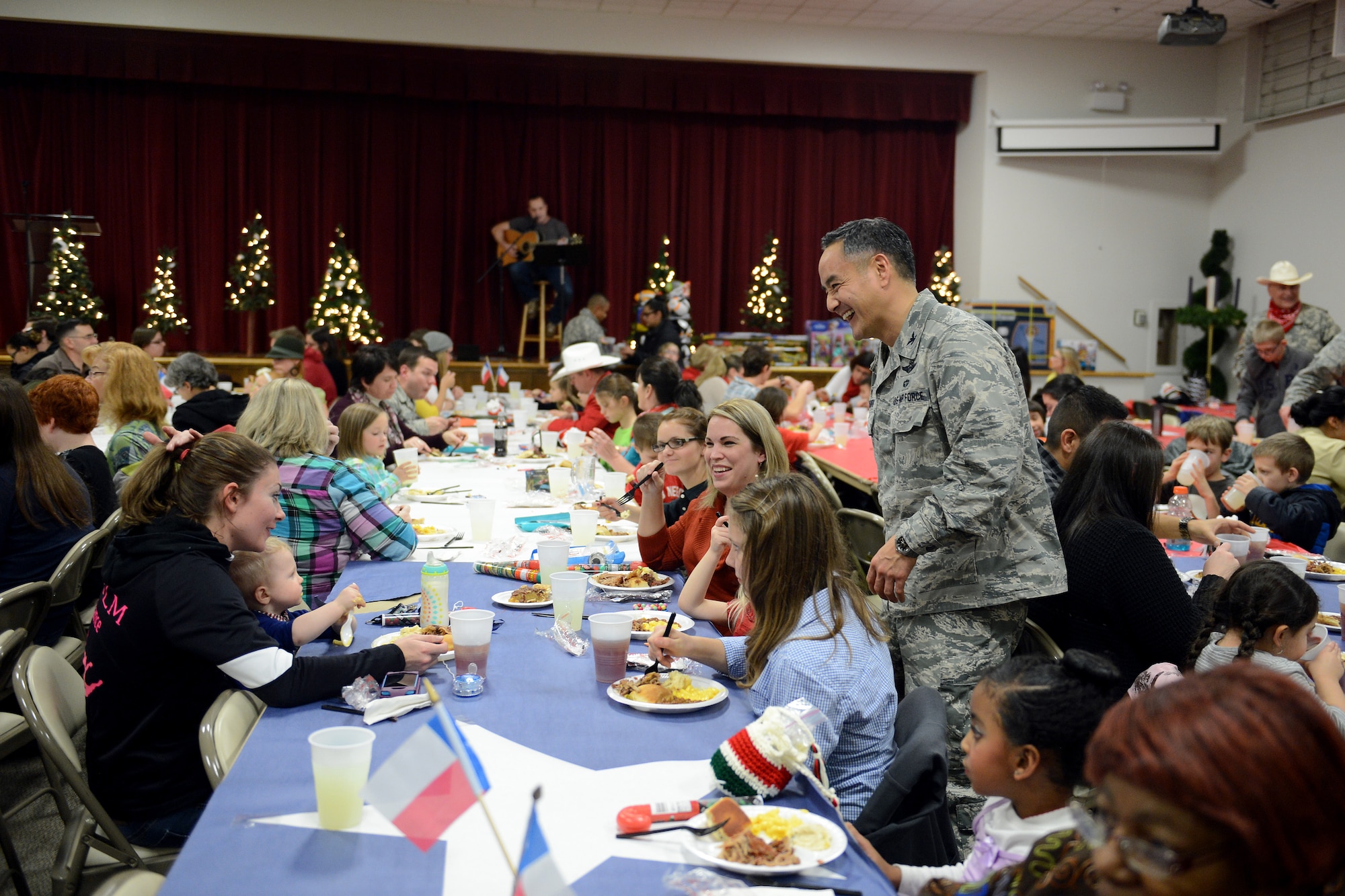 Col. David Kumashiro, 62nd Airlift Wing commander, speaks to Team McChord families Dec. 8, 2014, during a deployed family dinner at the Chapel Support Center on Joint Base Lewis-McChord, Wash. Throughout the dinner, families were able to socialize with the commanders and other Airmen. (U.S. Air Force photo/Airman 1st Class Keoni Chavarria)