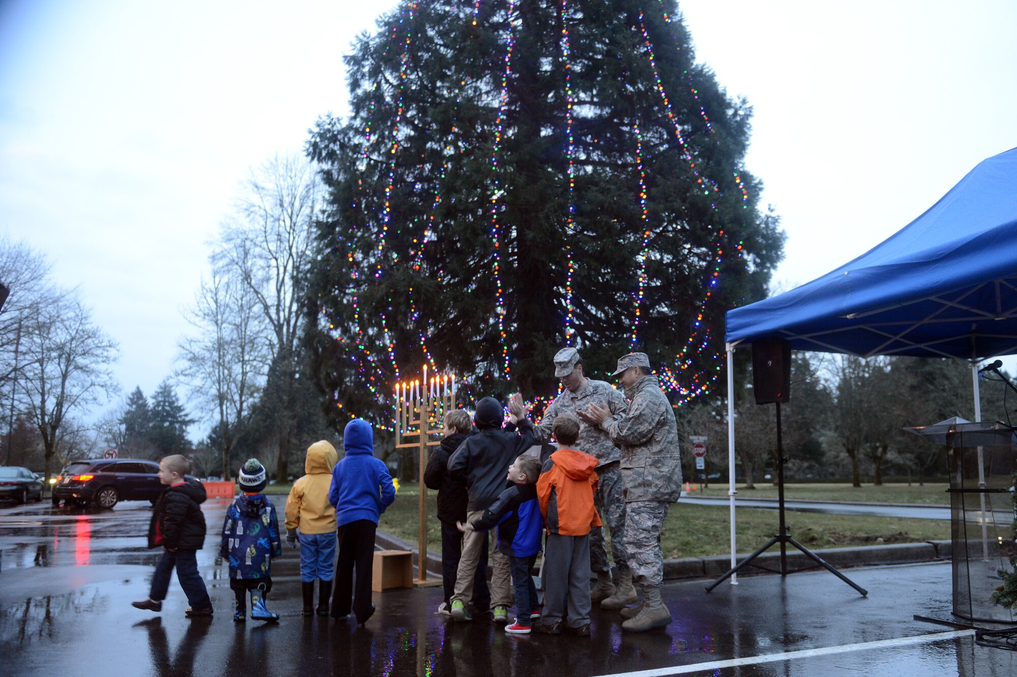 With the help of children, Col. David Kumashiro (right), 62nd Airlift Wing commander, and Col. Charles Hodges, Joint Base Lewis-McChord installation commander, turn the lights on a tree Dec. 8, 2014, during the McChord Field Annual Tree Lighting ceremony at Joint Base Lewis-McChord, Wash. The lights were put up on the tree with the help of the 627th Civil Engineer Squadron. (U.S. Air Force photo/Airman 1st Class Keoni Chavarria)