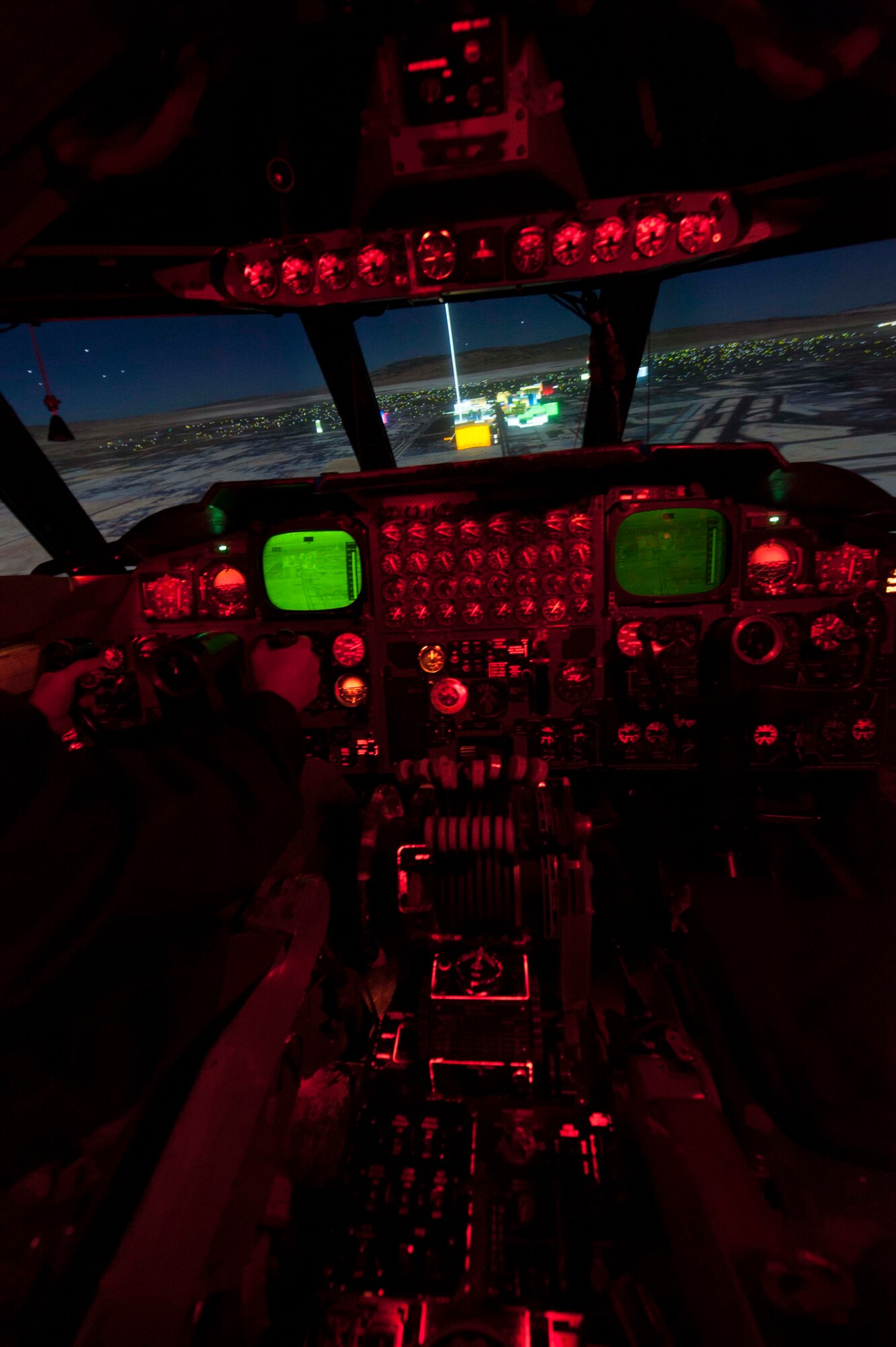 A simulation of the Las Vegas strip is viewed from the cockpit of the B52-H Stratofortress weapons system trainer during a simulated flight on Minot Air Force Base, N.D., Dec. 3, 2014. The WST conducts two large force exercises per week in addition to virtual flag exercises that last nine days and consist of five missions. They also partner with Airborne Warning and Control Squadrons, River Joints who identify ground threats and radars and tactical air control parties. (U.S. Air Force photo/Senior Airman Stephanie Morris)