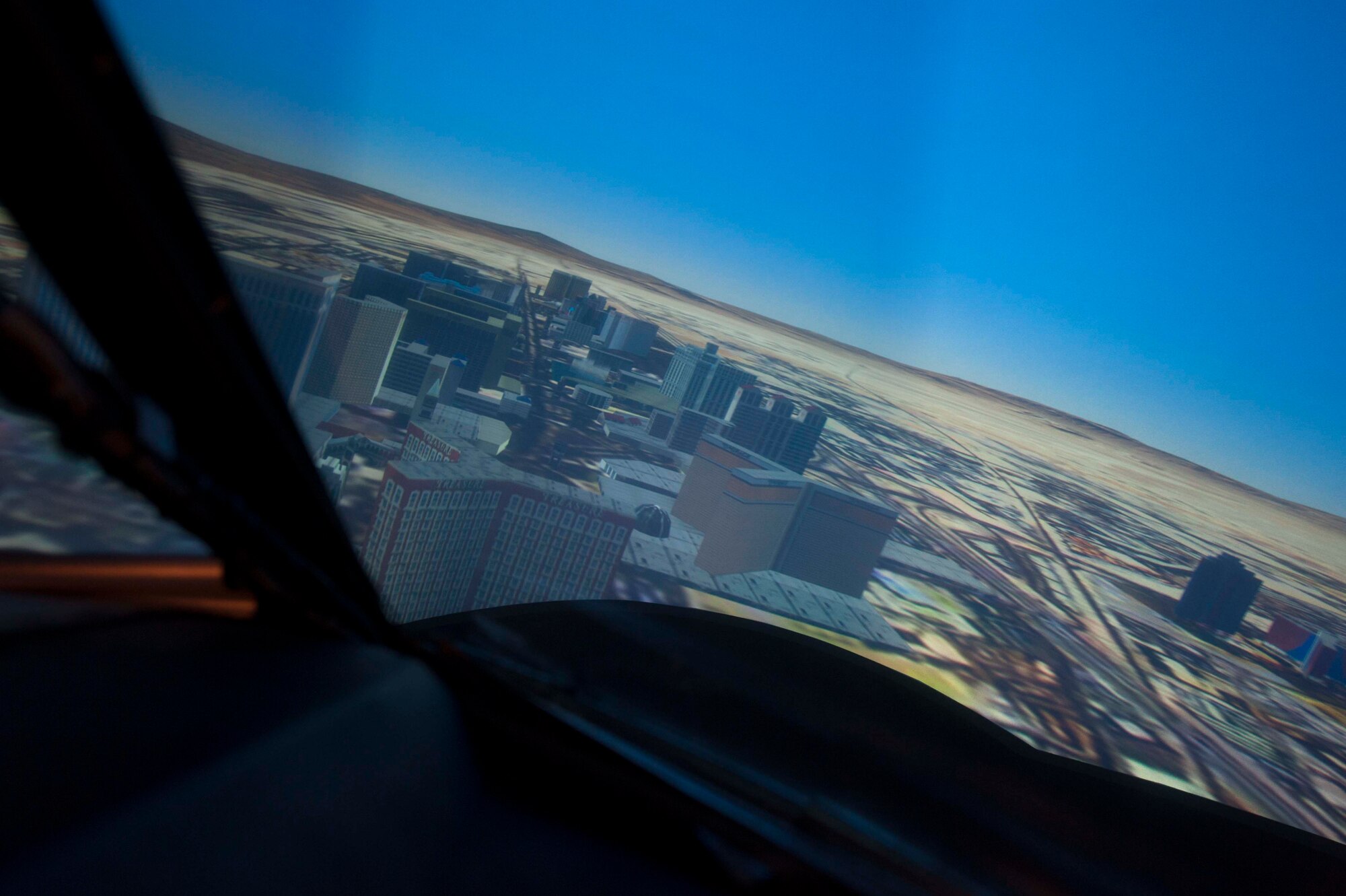 A simulation of the Las Vegas strip is viewed from the cockpit of the B52-H Stratofortress weapons system trainer during a simulated flight on Minot Air Force Base, N.D., Dec. 3, 2014. The WST conducts two large force exercises per week in addition to virtual flag exercises that last nine days and consist of five missions. They also partner with Airborne Warning and Control Squadrons, River Joints who identify ground threats and radars and tactical air control parties. (U.S. Air Force photo/Senior Airman Stephanie Morris)