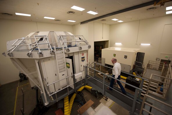 Jim Hogan, 5th Operations Support Squadron contractor and contracting officer representative, crosses a walkway to the B52-H Stratofortress weapons system trainer on Minot Air Force Base, N.D., Dec. 3, 2014. The WST has undergone many upgrades since its conception, including a $5 million update to video and defense system software in 2013. (U.S. Air Force photo/Senior Airman Stephanie Morris)