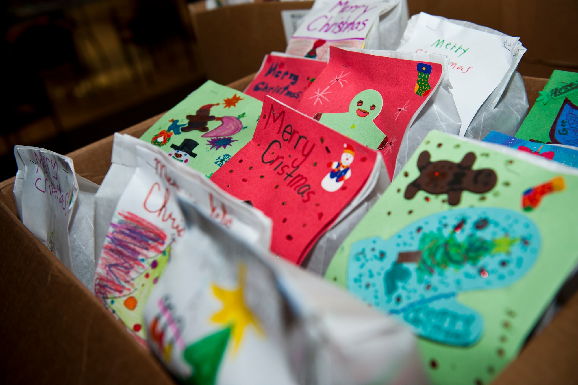 Cookies are packed in decorative bags and placed into boxes for the 2014 annual holiday cookie drive at Holloman Air Force Base, N.M., Dec. 8. Members of Team Holloman and the local community baked cookies for airmen living in the dorms on base to bring a little taste of home to those who might not be able to see their families for the holidays. (U.S. Air Force photo by Senior Airman Class Daniel Liddicoet/Released)
