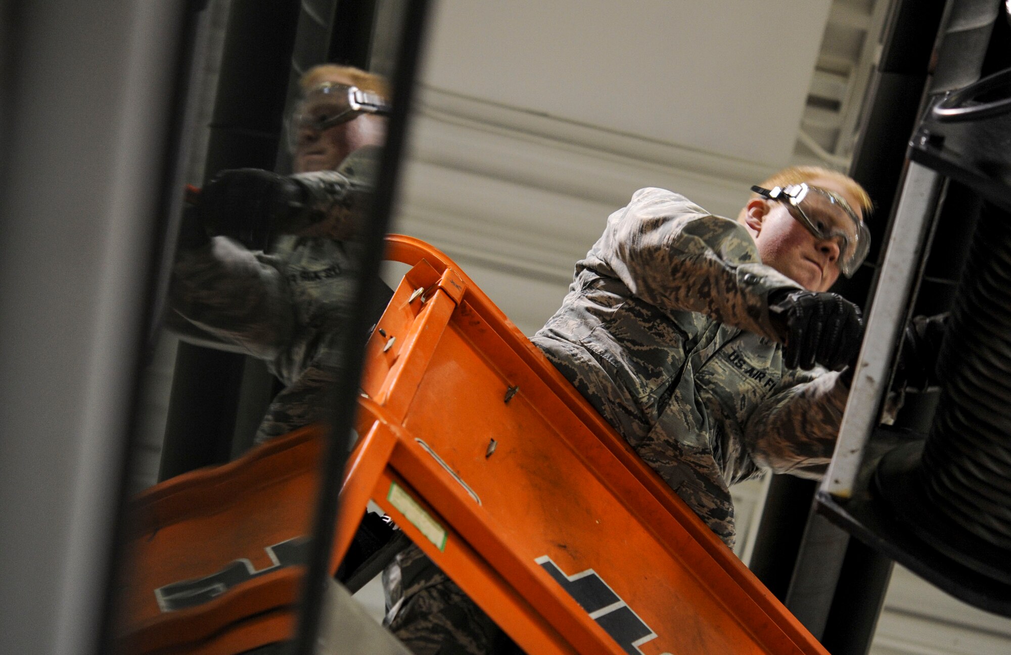 Senior Airman Brandon Gilmore, 91st Missile Operations Squadron mechanical and pneudraulics section technician, uses a hammer to reattach a new cable to a crane on Minot Air Force Base, N.D. Oct. 30, 2014. All of the technicians kept a constant dialog to ensure nothing was overlooked and the maintenance was completed safely. (U.S. Air Force photo/Senior Airman Stephanie Morris)