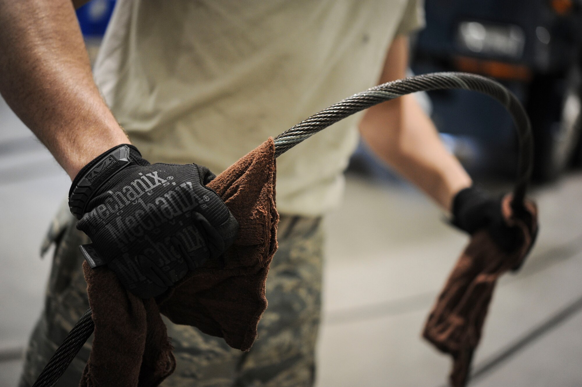 Airman 1st Class Robert Cook, 91st Missile Operations Squadron mechanical and pneudraulics section technician, checks a new cable for deficiencies during maintenance on a crane on Minot Air Force Base, N.D. Oct. 30, 2014. While performing checks Cook is constantly utilizing a two-person concept to ensure nothing is overlooked. (U.S. Air Force photo/Senior Airman Stephanie Morris)
