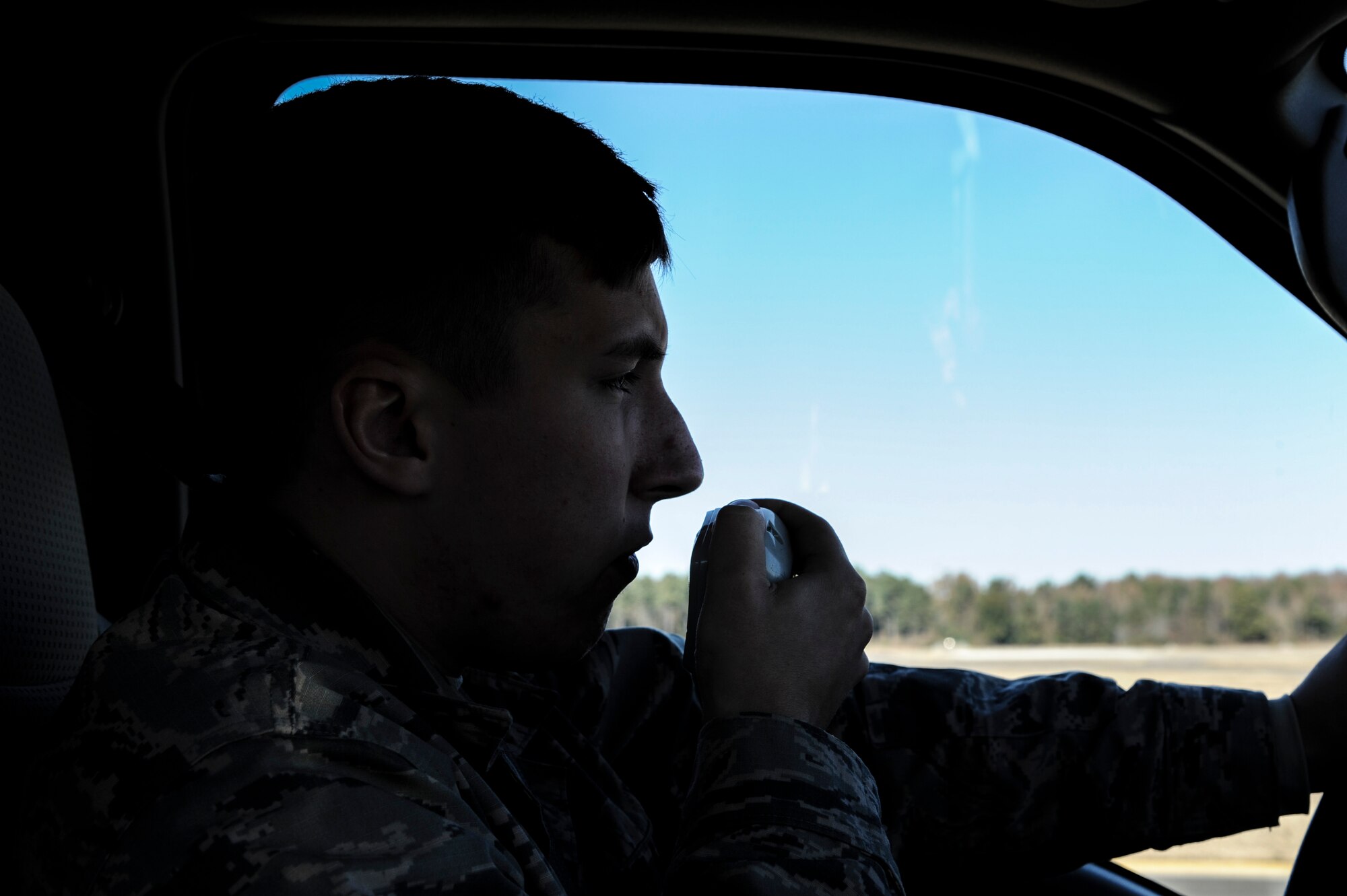 Airman 1st Class Wesley Shue, a 19th Operations Support Squadron airfield management operations coordinator, talks to the air traffic control tower via radio Nov. 18, 2014, at Little Rock Air Force Base, Ark. Shue coordinates with the tower as he drives on the airfield to do an inspection. (U.S. Air Force photo by Airman 1st Class Mercedes Muro) 