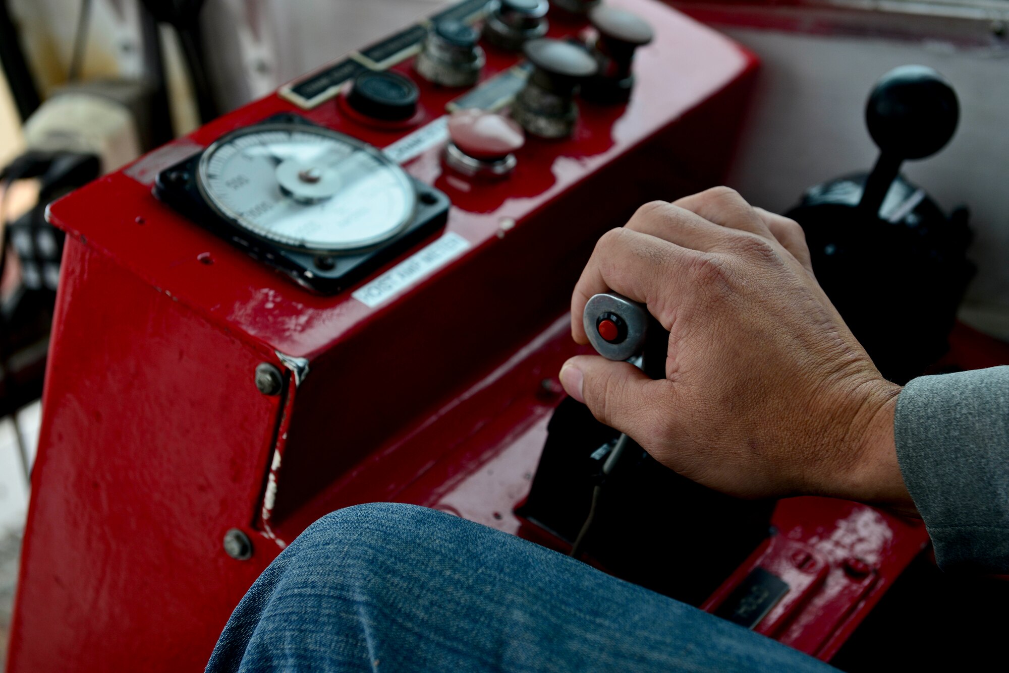 Corbin Singleton, crane operator, controls a spud-barge mounted crane during a dredging mission in the waters of the 3rd Port at Fort Eustis, Va., Dec. 9, 2014. The mission, which began Nov. 15, is projected to be completed by Dec. 15. (U.S. Air Force photo by Senior Airman Kimberly Nagle/Released)