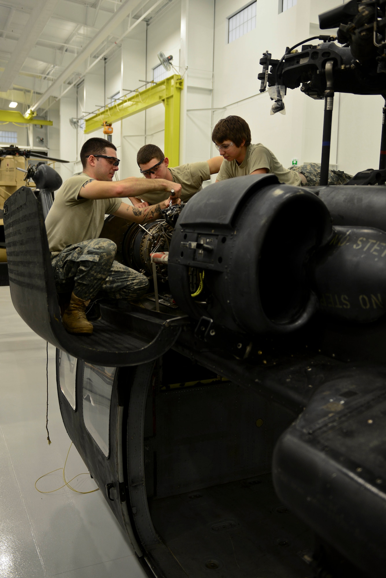 U.S. Army Advanced Individual Training students assigned to the 128th Aviation Brigade work on the Super 62 “Black Widow,” a new training aid at Fort Eustis, Va., Dec. 9, 2014. The new training aid will assist future Blackhawk helicopter maintainers and electricians by having the ability to create mistakes via computers for the students to fix. (U.S. Air Force photo by Senior Airman Kimberly Nagle/Released)
