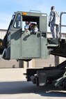 Staff Sgt. Andrew Anderson, 73rd Aerial Port Squadron ramp agent and driver, checks the hydraulics status on a Tunner 60k aircraft cargo loader/transporter prior to his equipment operations training at Naval Air Station Fort Worth Joint Reserve Base, Texas, Dec. 6, 2014. The machine, borrowed from the 502nd Logistics Readiness Squadron, Joint Base San Antonio, Texas, and delivered on a 433rd Airlift Wing C-5, provided an historic opportunity for nearly 30 aerial port Airmen to receive crucial combat training requirements prior to a deployment. (U.S. Air Force photo by Master Sgt. Julie Briden-Garcia)