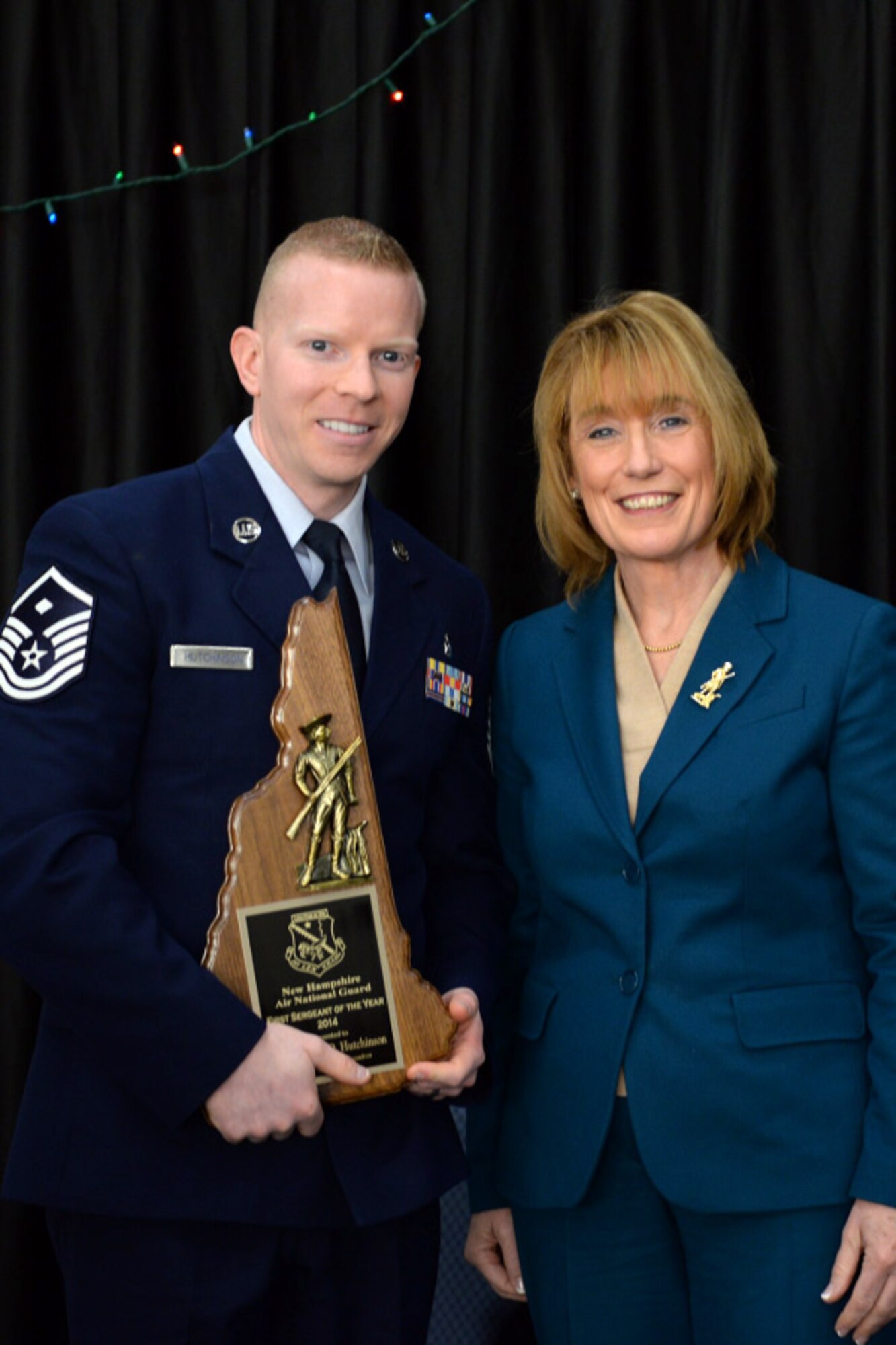 Master Sgt. Jeremy Hutchinson with the 157th Mission Support Group is presented the 157th Air Refueling Wing's 1st Sgt. of the Year award by N.H. Governor Maggie Hassan, Pease Air National Guard Base, N.H., Dec 7, 2014. (Air National Guard photo by Staff Sgt. Curtis J. Lenz/Released)