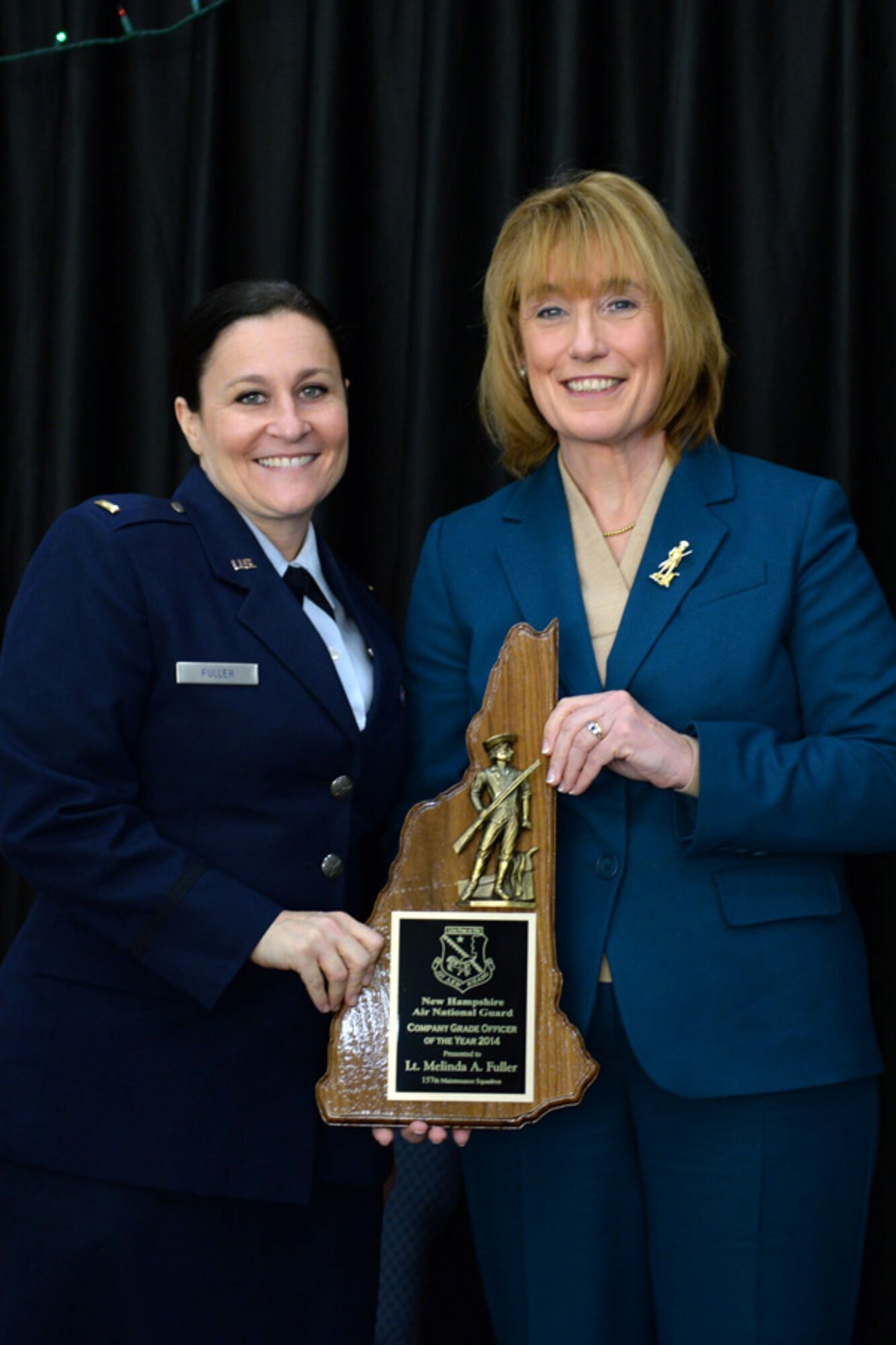 2nd Lt. Melinda Fuller with the 157th Maintenance Group is presented the 157th Air Refueling Wing's Company Grade Officer of the Year award by N.H. Governor Maggie Hassan, Pease Air National Guard Base, N.H., Dec 7, 2014. (Air National Guard photo by Staff Sgt. Curtis J. Lenz/Released)