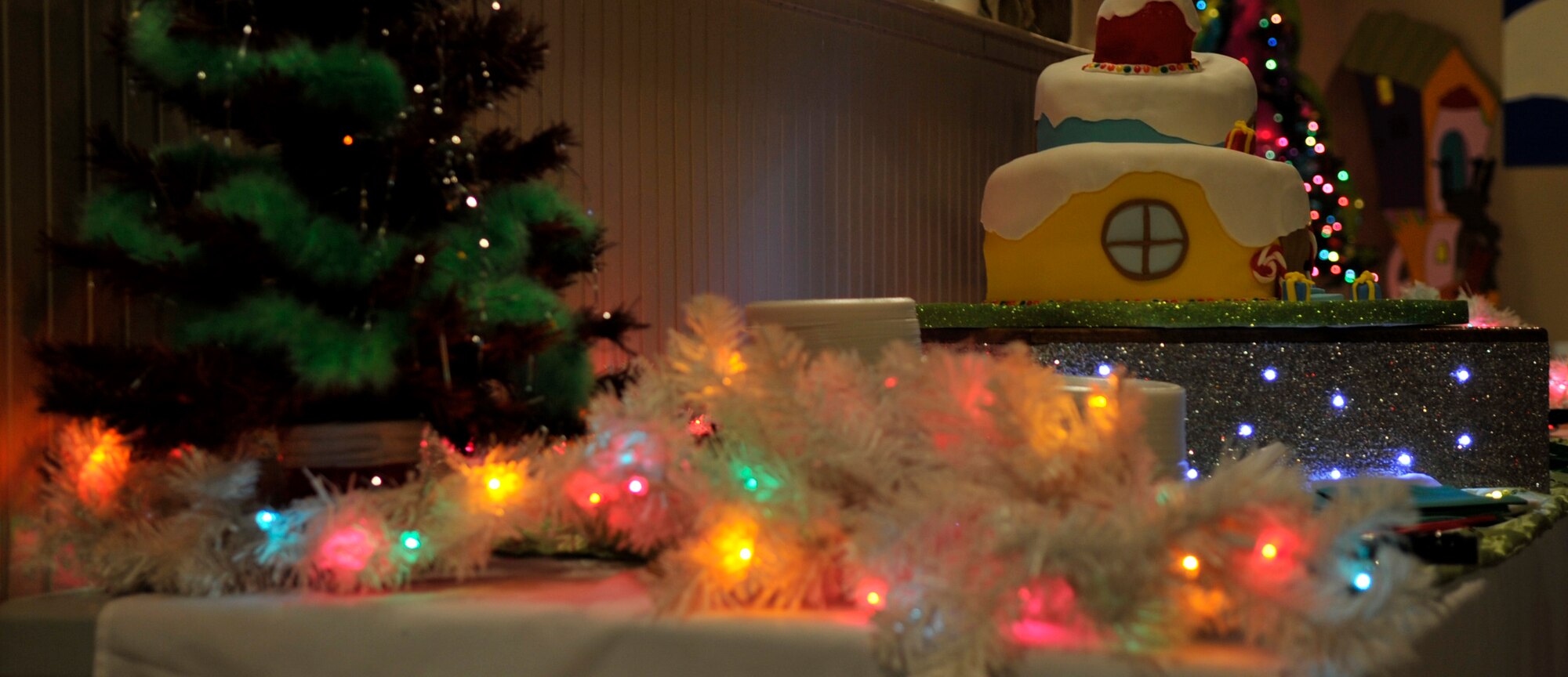 Holiday ornaments and cake are displayed Dec. 5 at the Hearts Apart Who-liday Party. Other decorations consisted of Grinch themed paintings made by volunteers and were displayed during the event. (U.S. Air Force photo by Airman 1st Class Ty-Rico Lea)