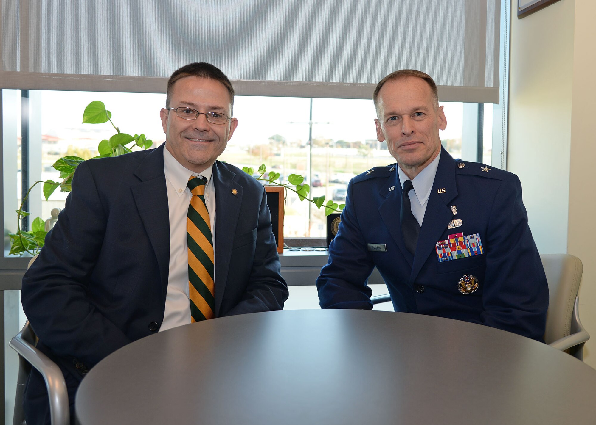 Brig. Gen. James McClain, Air Force Medical Support Agency commander, meets with Dr. W. Scott Jones, San Antonio Uniformed Services Health Education Consortium dean, during a visit to the San Antonio Military Medical Center, Joint Base San Antonio-Fort Sam Houson, Texas, Dec. 8, 2014. McClain and Jones met briefly to discuss the evolving opportunities of integrated allied health care. McClain served as keynote speaker during the SAUSHEC Winter Commencement ceremony, and visited the 959th Medical Group Biomedical Science Corps areas at SAMMC and later 59th Medical Wing BSC areas at the Wilford Hall Ambulatory Surgical Center on JBSA-Lackland. (U.S. Air Force photo/Staff Sgt. Christopher Carwile)