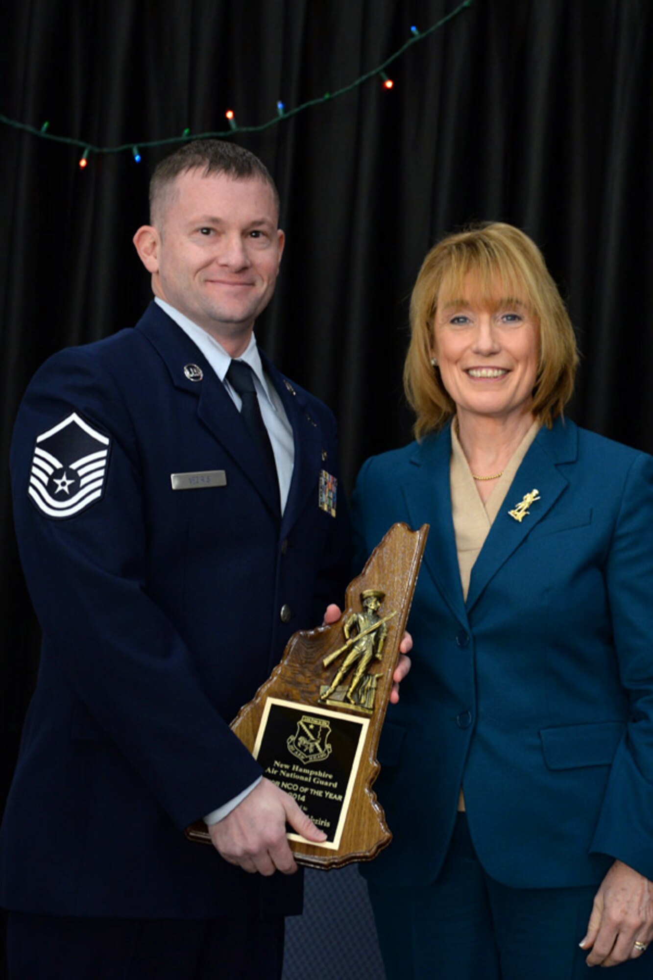 Master Sgt. Jason Veziris with the 157th Operations Squadron is presented the 157th Air Refueling Wing's Senior Non-Commissioned Officer of the Year award by N.H. Governor Maggie Hassan, Pease Air National Guard Base, N.H., Dec 7, 2014. (Air National Guard photo by Staff Sgt. Curtis J. Lenz/Released)