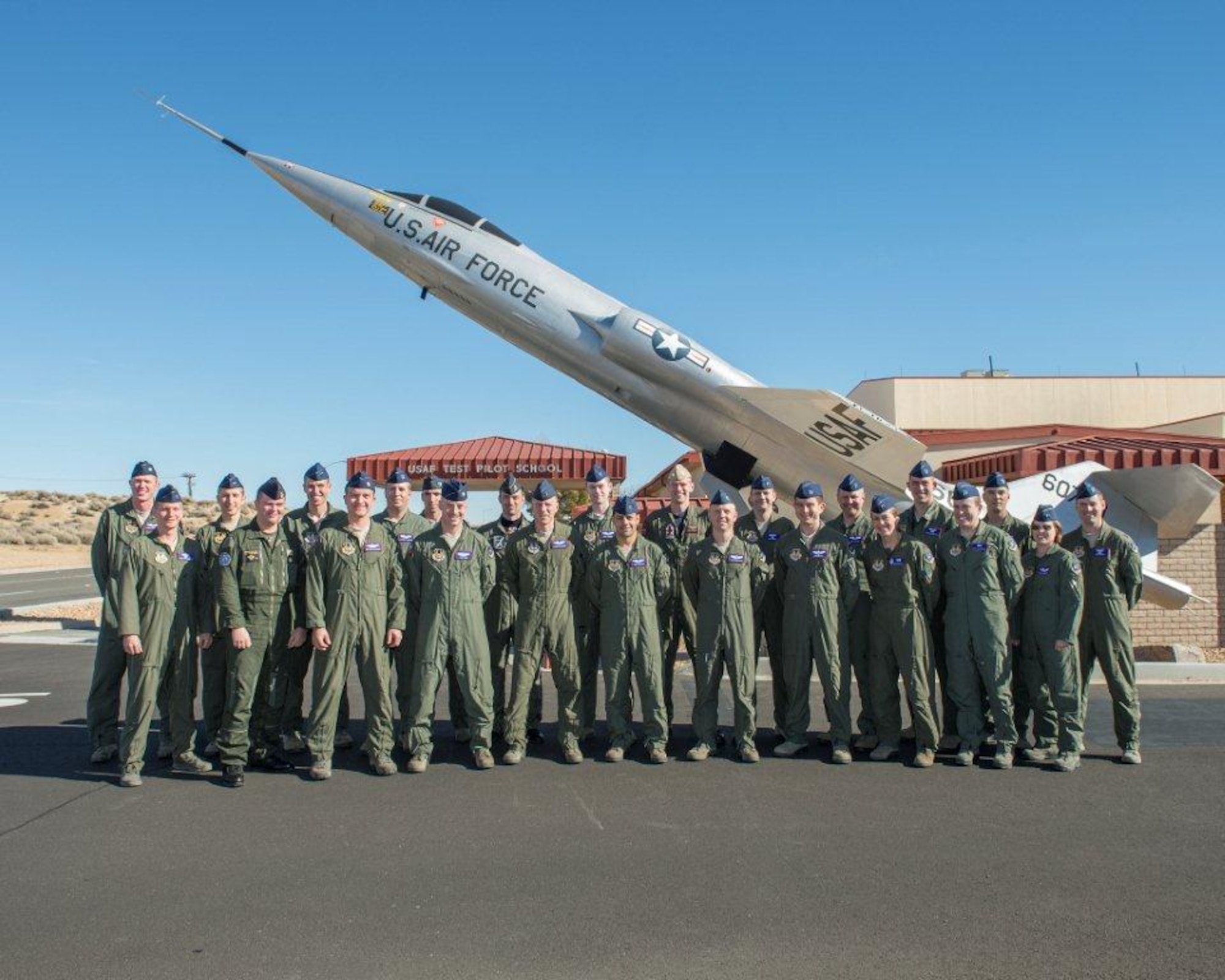 U.S. Air Force Test Pilot School Class 14A pose for a class photo in front of the NF-104 at the school house. Class 14A graduates Dec. 12. The comprehensive curriculum of TPS is fundamental to the success of flight test and evaluation. Upon graduating, graduates will have earned a Master of Science Degree in Flight Test Engineering. (U.S. Air Force photo by Edward Cannon) 
