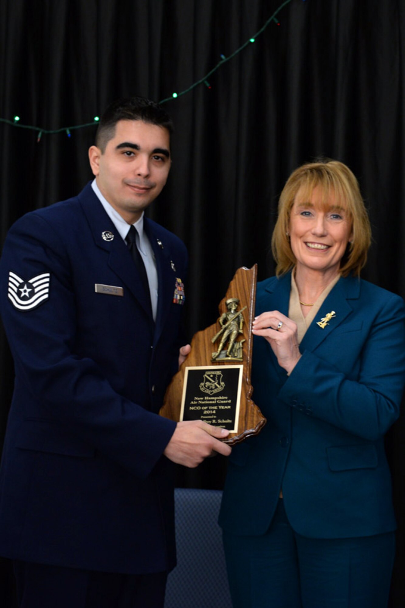 Tech Sgt. Geoffrey Schultz with the 64th Air Refueling Squadron is presented the 157th Air Refueling Wing's Non-Commissioned Officer of the Year award by N.H. Governor Maggie Hassan, Pease Air National Guard Base, N.H., Dec 7, 2014. (Air National Guard photo by Staff Sgt. Curtis J. Lenz/Released)