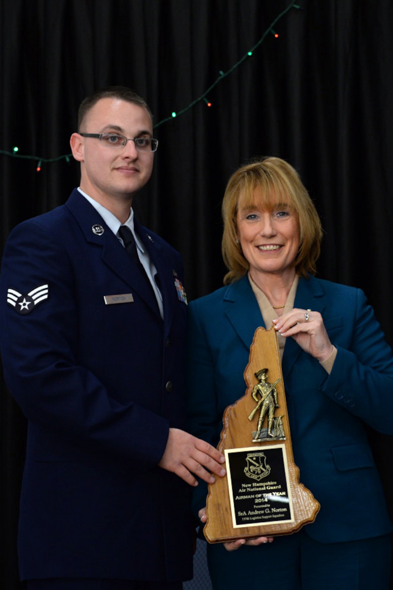 Senior Airman Andrew Norton with the 157th Logistics Readiness Squadron is presented the 157th Air Refueling Wing's Airman of the Year award by N.H. Governor Maggie Hassan, Pease Air National Guard Base, N.H., Dec 7, 2014. (Air National Guard photo by Staff Sgt. Curtis J. Lenz/Released)