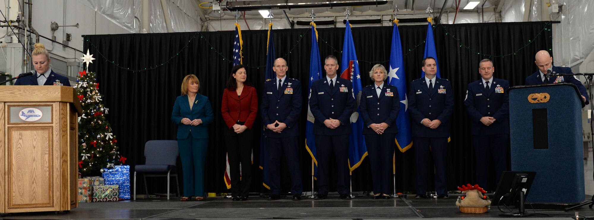 Senior leaders of the New Hampshire Air National Guard prepare to present awards to airmen during an annual awards ceremony which highlights the top airmen from the wing, Pease Air National Guard Base, N.H., Dec 7, 2014.  Onstage to present the awards are (from left) Tech Sgt. Kimbery Comstock, N.H. Governor Maggie Hassan, U.S. Senator Kelley Ayotte, N.H. Adjutant General Maj. Gen. William N. Reddel, State Command Chief Master Sgt. Matthew Collier, N.H. Air National Guard Commander Brig. Gen. Carolyn Protzmann, 157th Air Refueling Wing Commander Shawn Burrus, Wing Command Master Sgt. James Lawrence, and Tech. Sgt. Jeffrey Inferrere. (Air National Guard photot by Staff Sgt. Curtis J. Lenz/Released)