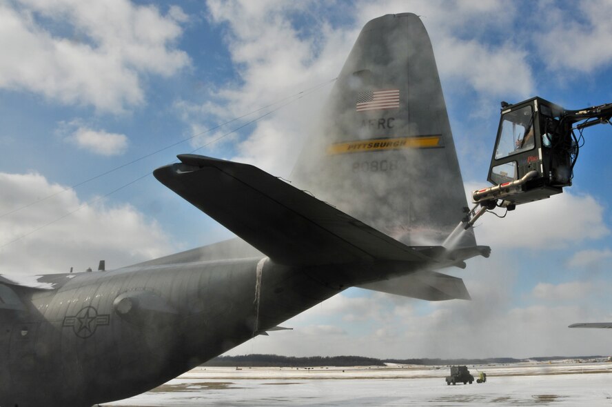 A C-130 Hercules is prepared for a tactical drop training flight by members of the 911th Aircraft Maintenance Squadron, the 911th Operations Support Squadron and the 758th Airlift Squadron during subzero weather at Pittsburgh International Airport Air Reserve Station, Jan. 22, 2014. During the winter months, aircraft must go through many steps before it is ready to fly. These steps include being towed from their parked location to a de-icing pad, heating the engines to ensure the propellers aren’t frozen in place, and then the normal preflight inspections and equipment loading. (U.S. Air Force illustration photo by Senior Airman Joshua J. Seybert)