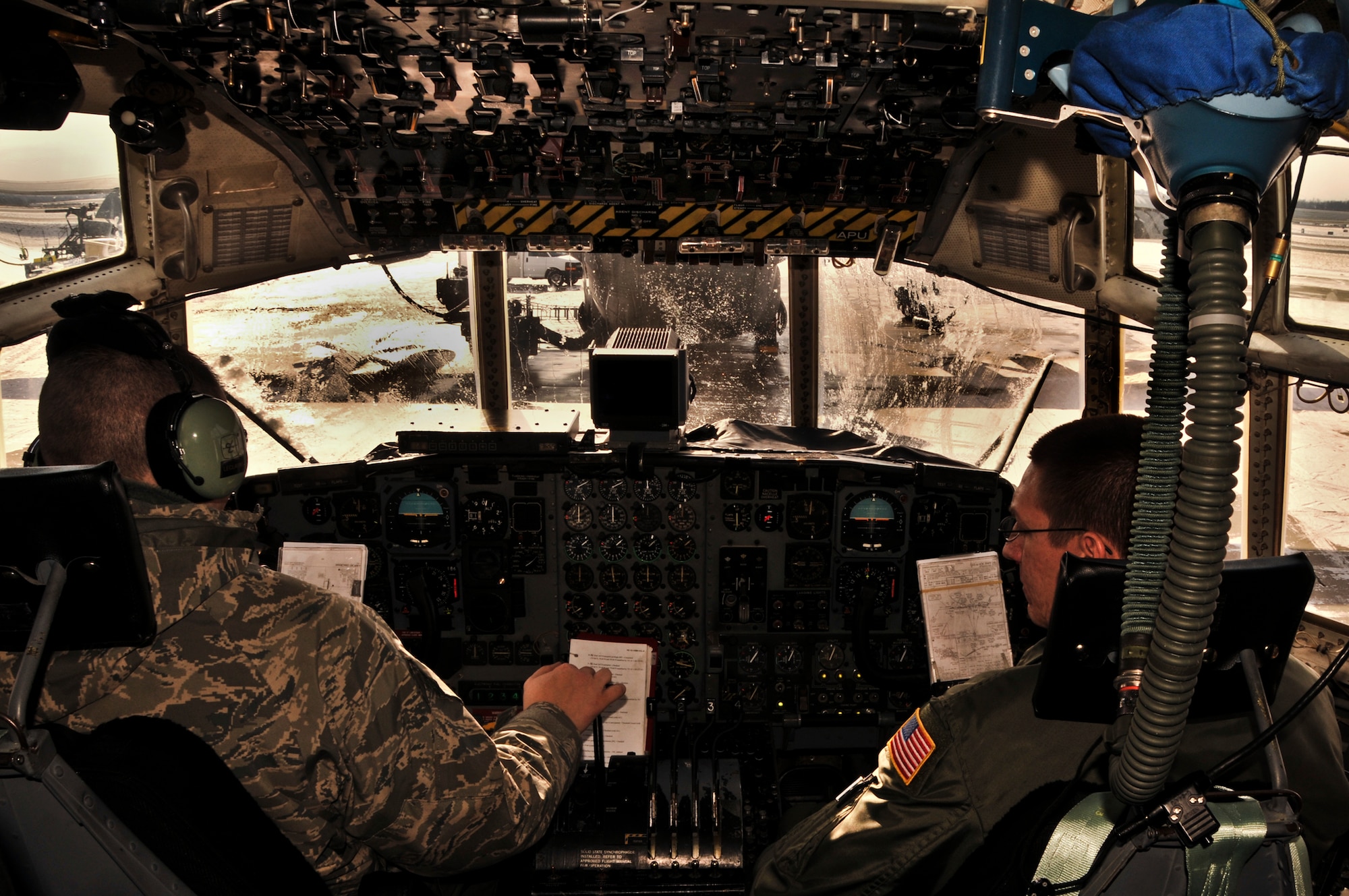 A C-130 Hercules is prepared for a tactical drop training flight by members of the 911th Aircraft Maintenance Squadron, the 911th Operations Support Squadron and the 758th Airlift Squadron during subzero weather at Pittsburgh International Airport Air Reserve Station, Jan. 22, 2014. During the winter months, aircraft must go through many steps before it is ready to fly. These steps include being towed from their parked location to a de-icing pad, heating the engines to ensure the propellers aren’t frozen in place, and then the normal preflight inspections and equipment loading. (U.S. Air Force illustration photo by Senior Airman Joshua J. Seybert)