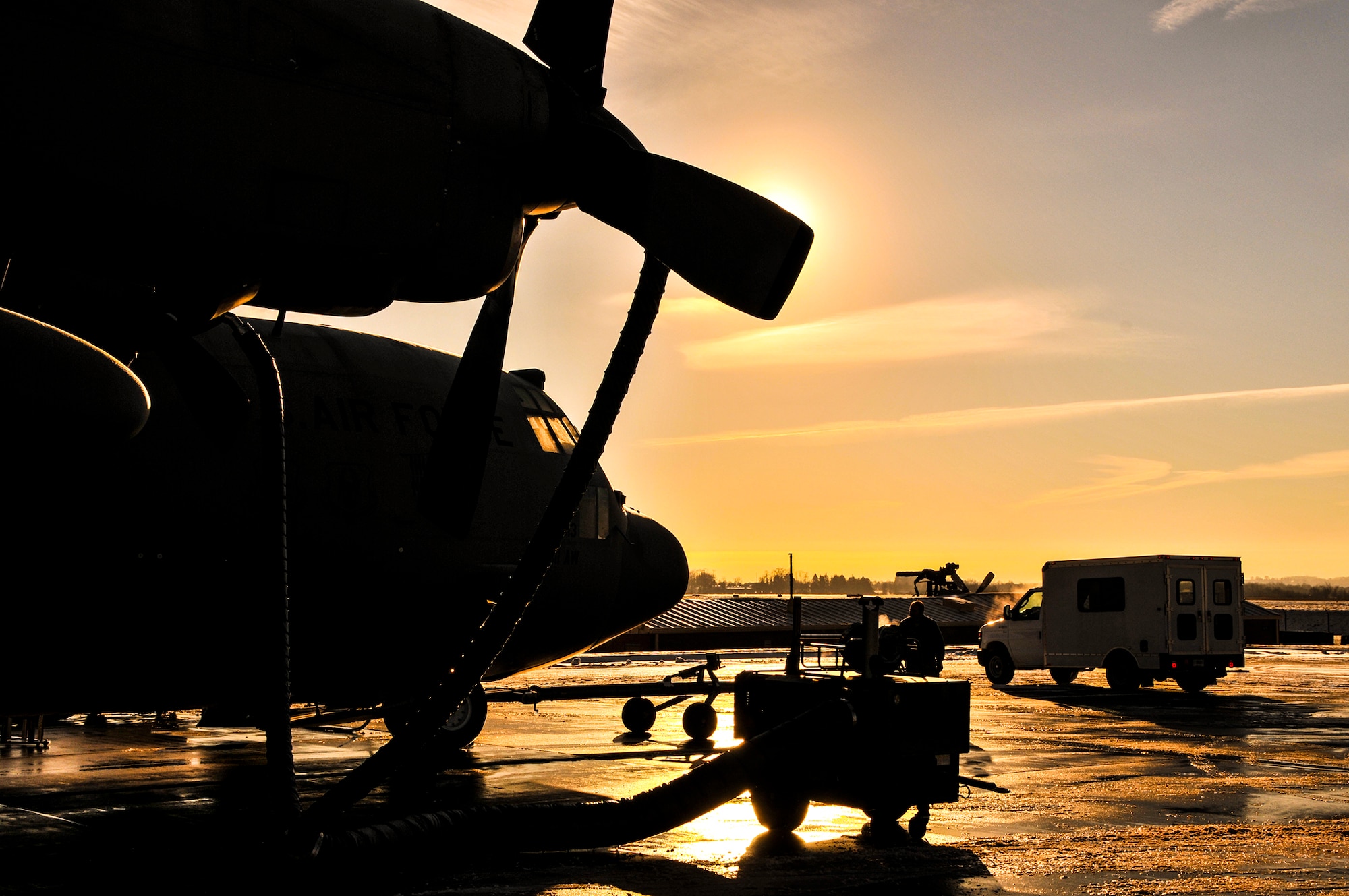 A C-130 Hercules is prepared for a tactical drop training flight by members of the 911th Aircraft Maintenance Squadron, the 911th Operations Support Squadron and the 758th Airlift Squadron during subzero weather at Pittsburgh International Airport Air Reserve Station, Jan. 22, 2014. During the winter months, aircraft must go through many steps before it is ready to fly. These steps include being towed from their parked location to a de-icing pad, heating the engines to ensure the propellers aren’t frozen in place, and then the normal preflight inspections and equipment loading. (U.S. Air Force illustration photo by Senior Airman Joshua J. Seybert)