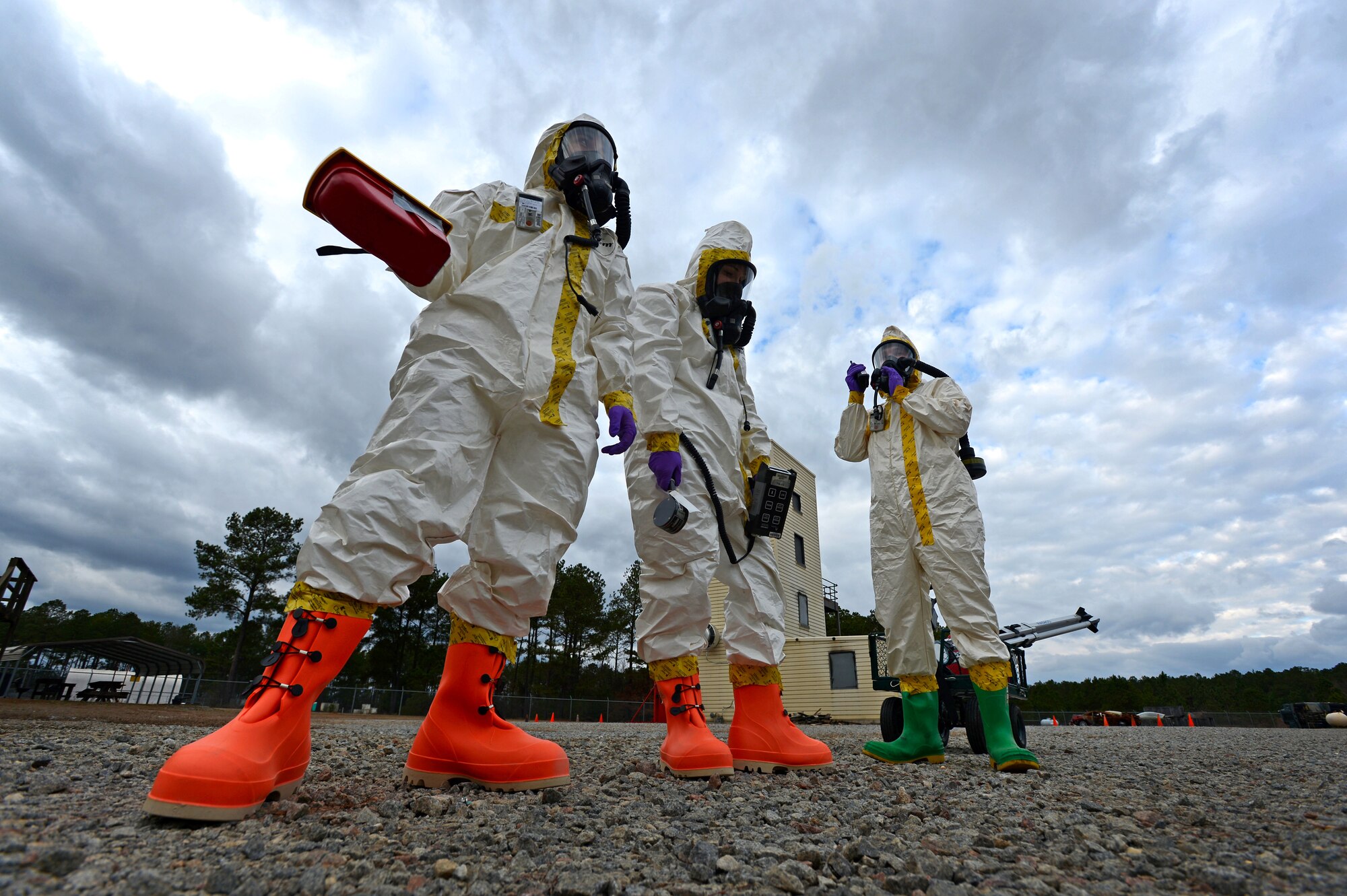 (From left) U.S. Air Force Senior Airmen Chantal Hogue and Lauren Yancey, 20th Civil Engineer Squadron emergency management apprentices, and Senior Airman Jordan Gagne, 20th Aerospace Medicine Squadron bioenvironmental engineering journeyman, participate in an integrated base emergency response capability training exercise at Shaw Air Force Base, S.C., Dec. 9, 2014.  The three Airmen were the initial entry team, the first to enter the simulated contaminated area to test for hazardous material. (U.S. Air Force photo by Airman 1st Class Jensen Stidham/Released)