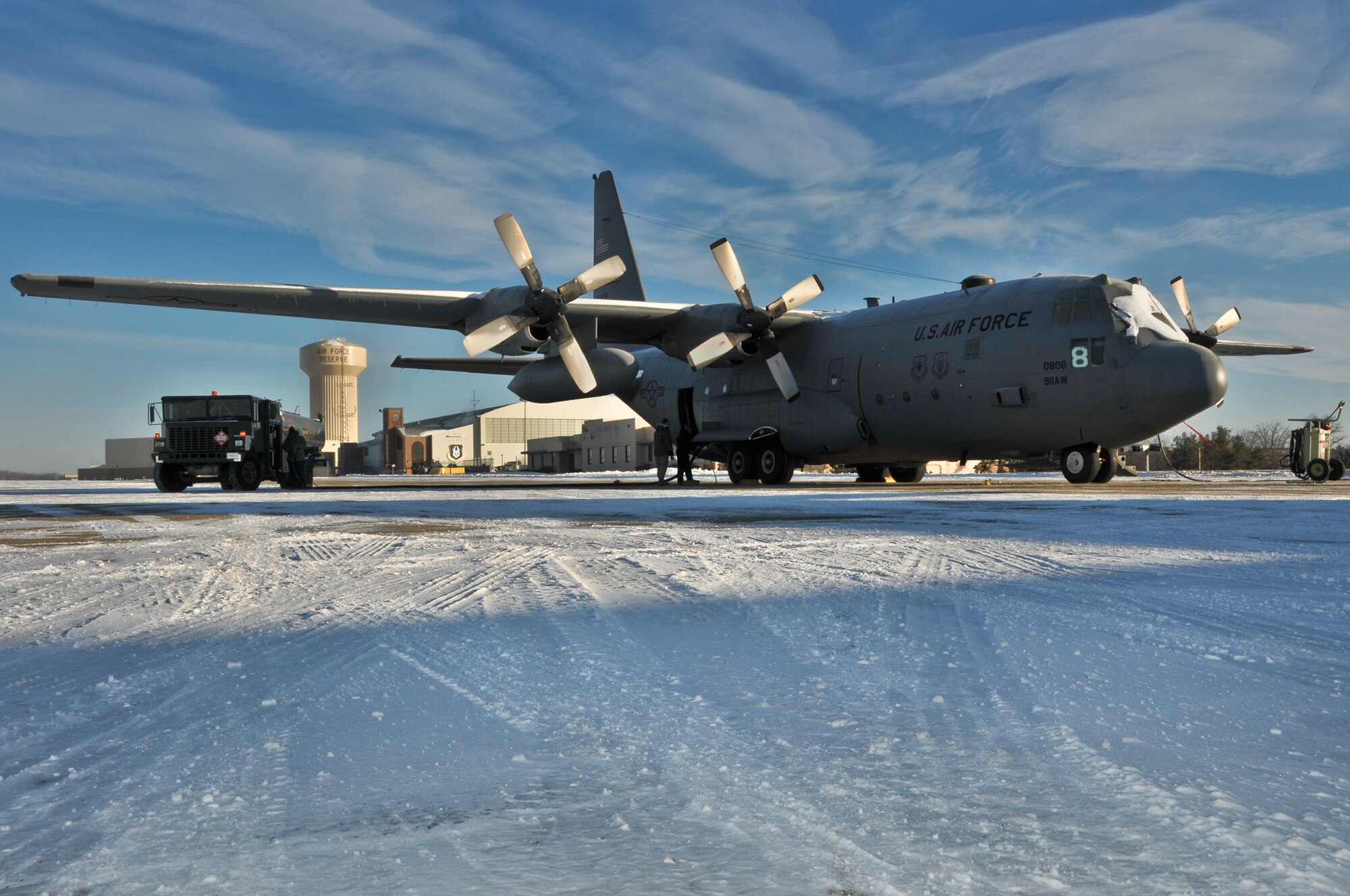 A C-130 Hercules is prepared for a tactical drop training flight by members of the 911th Aircraft Maintenance Squadron, the 911th Operations Support Squadron and the 758th Airlift Squadron during subzero weather at Pittsburgh International Airport Air Reserve Station, Jan. 22, 2014. During the winter months, aircraft must go through many steps before it is ready to fly. These steps include being towed from their parked location to a de-icing pad, heating the engines to ensure the propellers aren’t frozen in place, and then the normal preflight inspections and equipment loading. (U.S. Air Force illustration photo by Senior Airman Joshua J. Seybert)