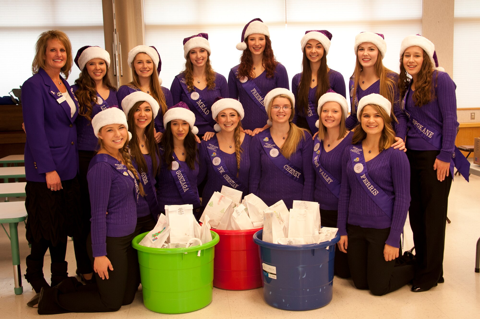 Spokane Lilac Festival’s FAB 14 pose for a picture Dec. 8, 2014, at Fairchild Air Force Base, Wash. The FAB 14 volunteered with the Officer’s Spouses Club to bag and distribute cookies to Airmen who live in the dormitories on base. (U.S. Air Force photo/Airman 1st Class Nicolo J. Daniello)