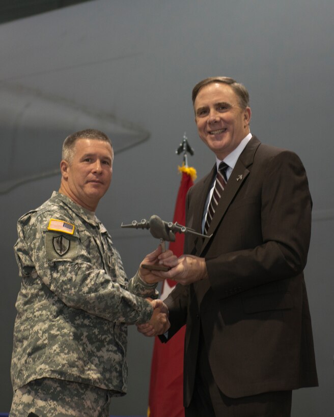 Maj. Gen. James Hoyer, the adjutant general for the West Virginia National Guard, is presented with a model of a C-17 Globemaster III during the introduction ceremony for the C-17 Globemaster III at Martinsburg, W.Va. air base, Dec. 6. Distinguished guests, visitors and family members were at the wing, for the introduction ceremony for the C-17 Globemaster III. The unit is currently going through a conversion from the C5 Galaxy.  After the ceremony, guests and family members enjoyed tours of the C-17 aircraft, along with various activities for kids.  (Air National Guard photo by Tech. Sgt. Mike Dickson/Released)