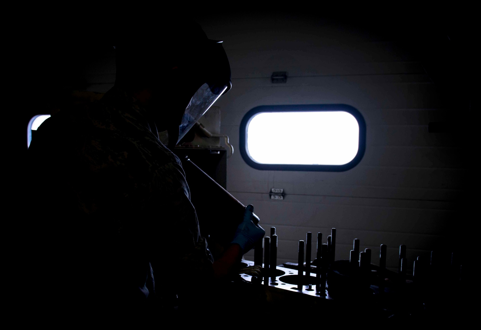Airman 1st Class Tom Bozeman, 91st Missile Maintenance Squadron facilities maintenance section technician, removes a cylinder sleeve from the engine block of a diesel generator on Minot Air Force Base. N.D., Nov. 25, 2014. Diesel generators are used to provide power to a site whenever commercial power is offline. (U.S. Air Force photo/Airman 1st Class Sahara L. Fales)