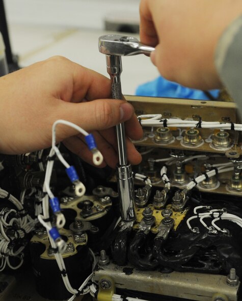 Senior Airman Colby Nash, 509th Maintenance Squadron electrical and environmental systems technician, works on a transformer rectifier at Whiteman Air Force Base, Mo., Nov. 25, 2014. The parts were designed to be maintenance free. (U.S. Air Force photo by Staff Sgt. Alexandra M. Boutte/Released)