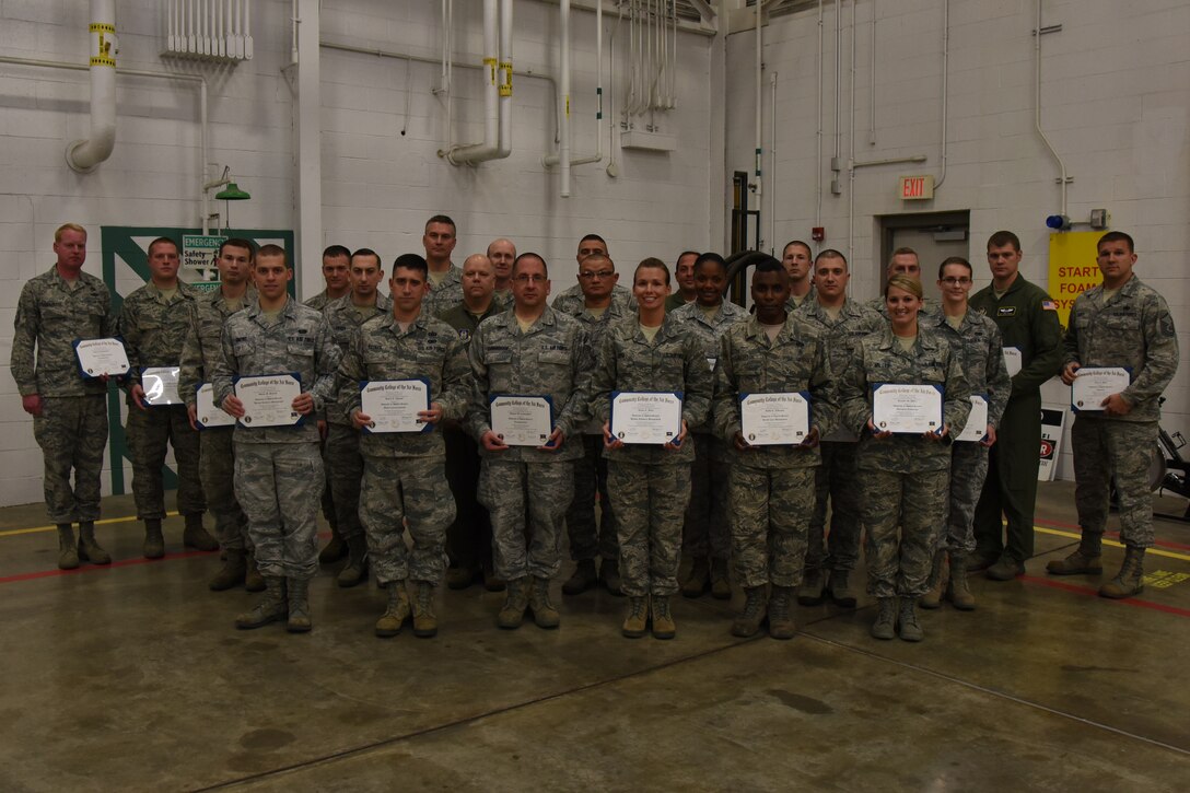 A group of Airmen stand with their Community College of the Air Force degrees during a commander’s call at the Pittsburgh International Airport Air Reserve Station, November 1, 2014. The most recent graduating class was comprised of 32 Airmen receiving 35 degrees, making it the largest graduating class in wing history. (U.S. Air Force photo by Senior Airman Joshua J. Seybert)
