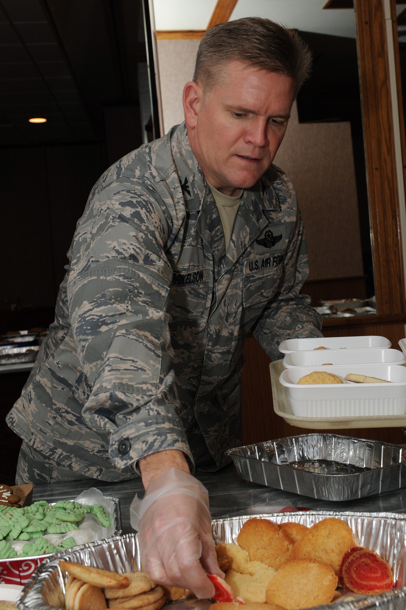 U.S. Air Force Col. Thomas Torkelson, 18th Wing vice commander, packs cookies into boxes for single service members during the holiday cookie drive on Kadena Air Base, Japan, Dec. 9, 2014. Each year, the holiday cookie drive collects thousands of home-made treats, which are then separated into individual portions and delivered to the Airmen, soldiers, sailors and Marines living in dormitories on Kadena. (U.S. Air Force photo by Airman 1st Class Zade C. Vadnais/Released) 
